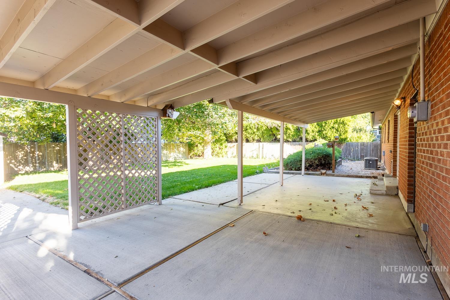 Fenced backyard with a patio