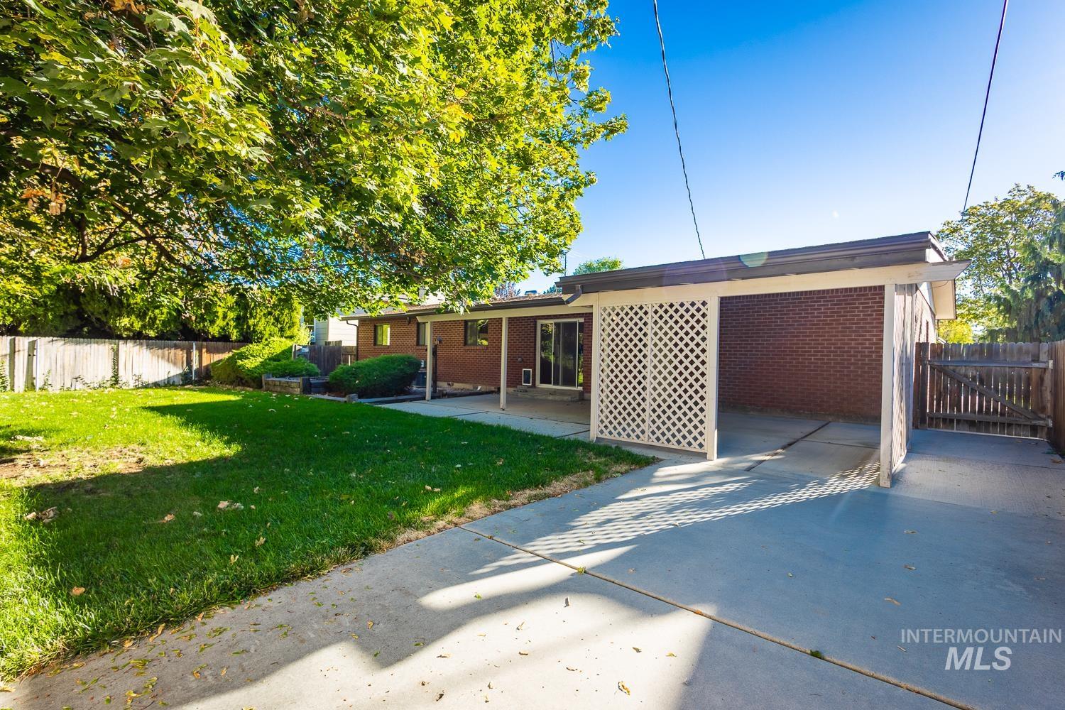 Back of property featuring brick siding and a patio