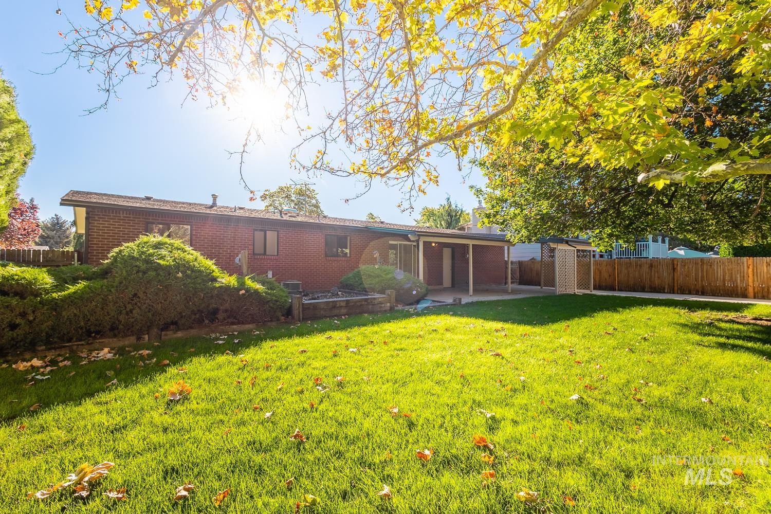 Rear view of property with a patio area and brick siding