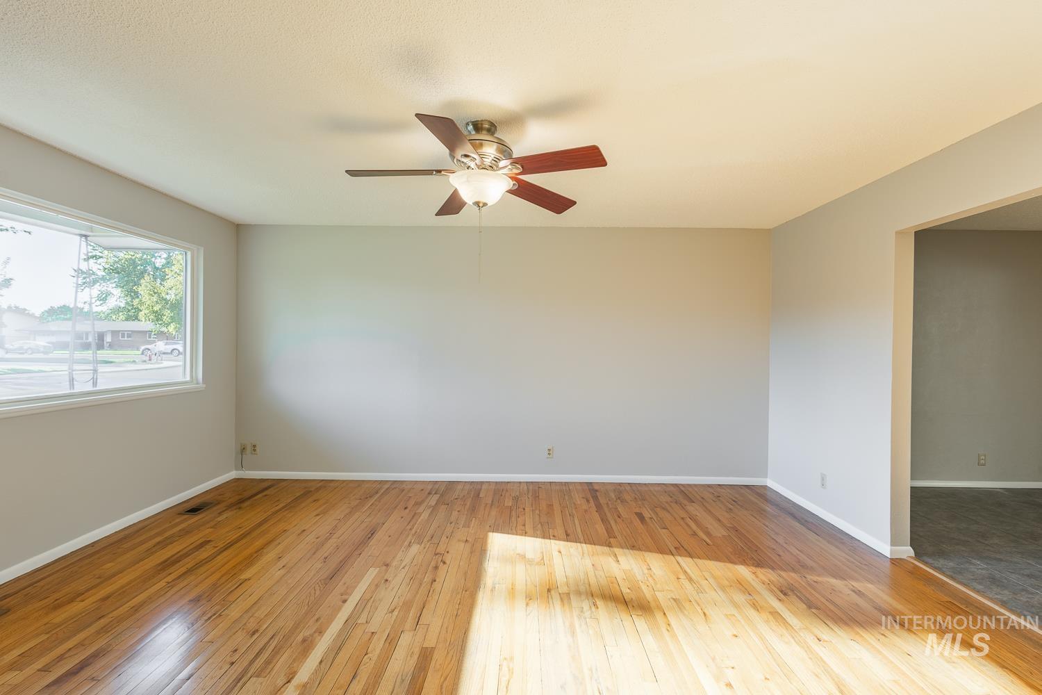 Unfurnished room featuring light wood-style floors and a ceiling fan