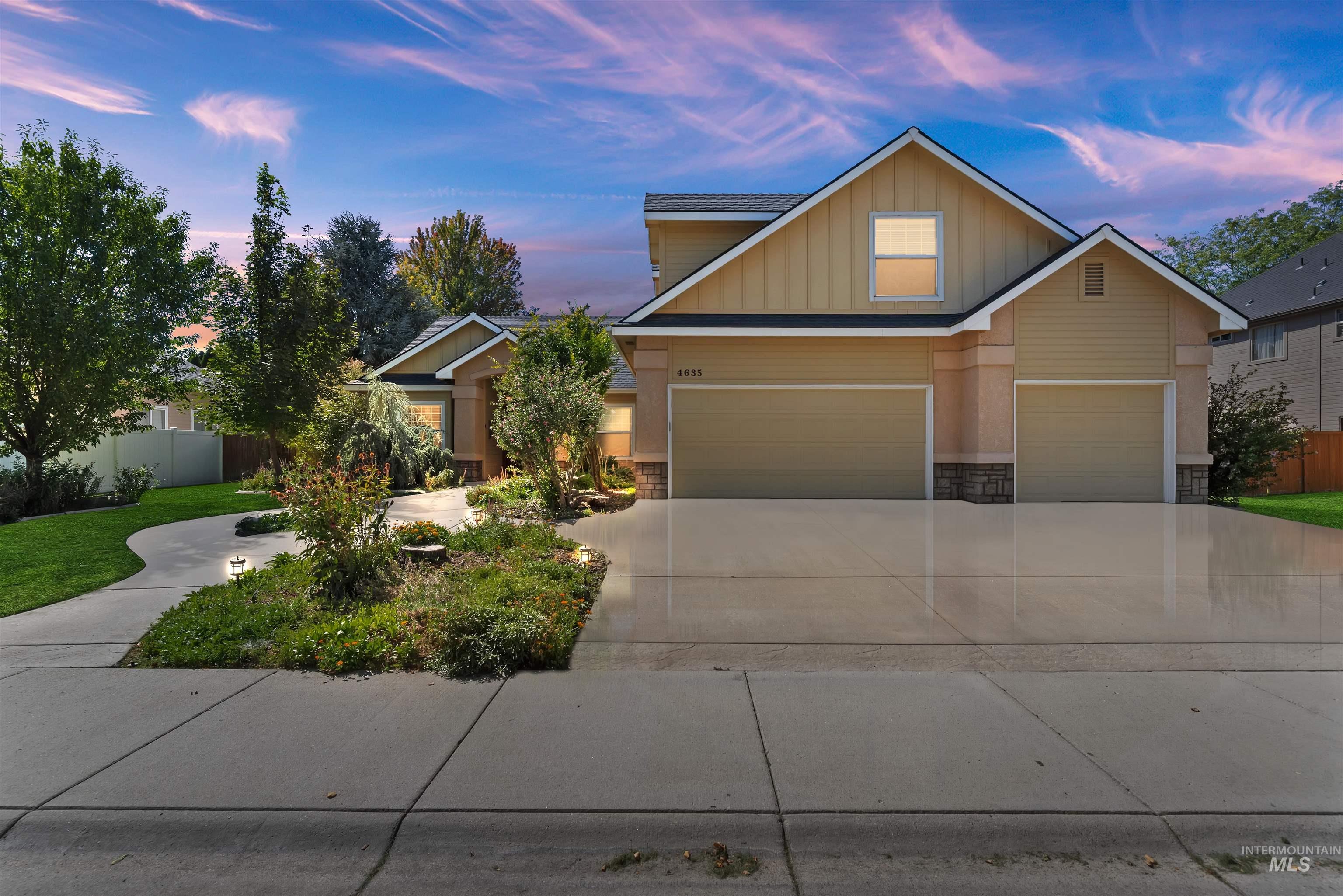 Craftsman house featuring stone siding, driveway, board and batten siding, and an attached garage