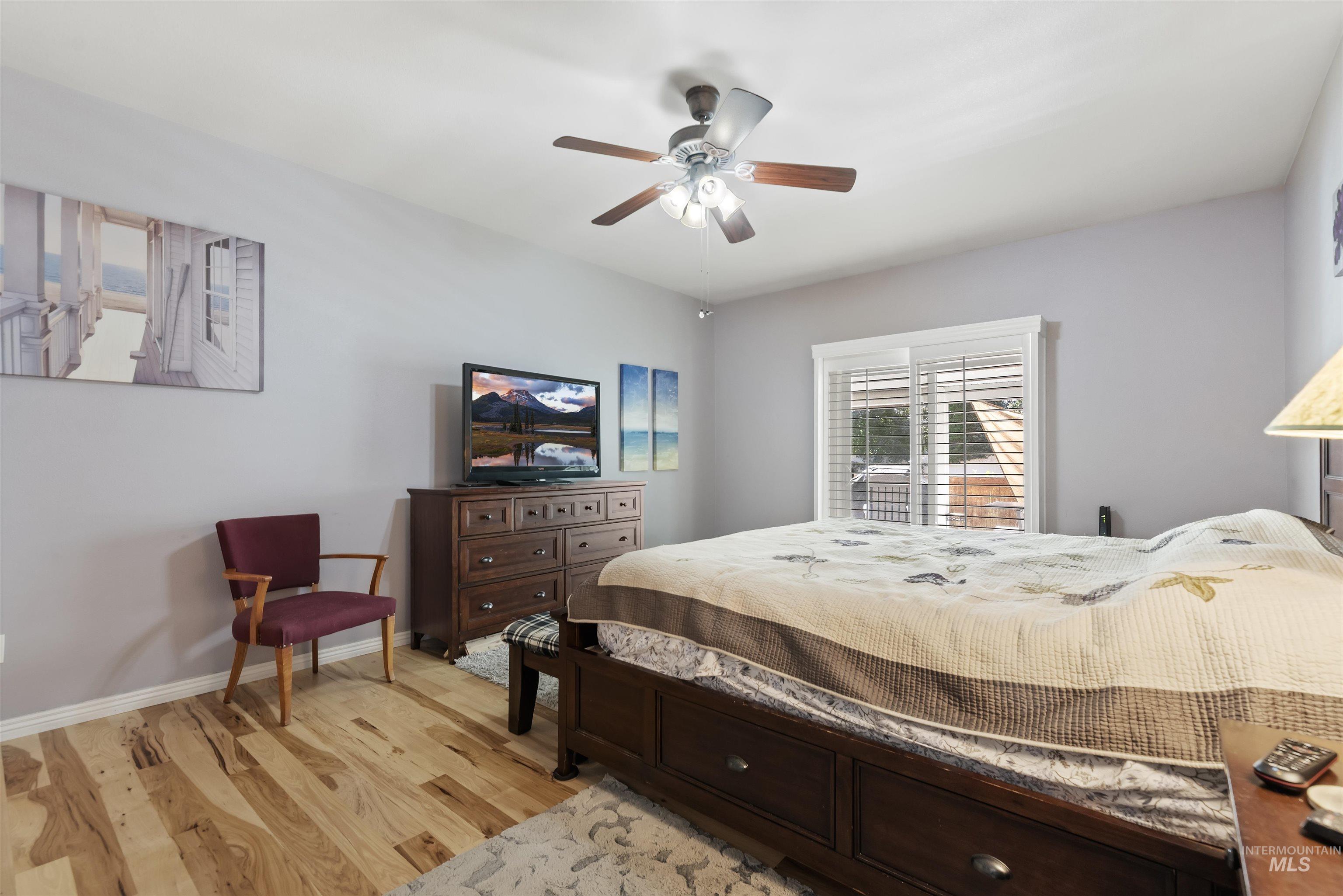 Bedroom with light wood-type flooring and ceiling fan