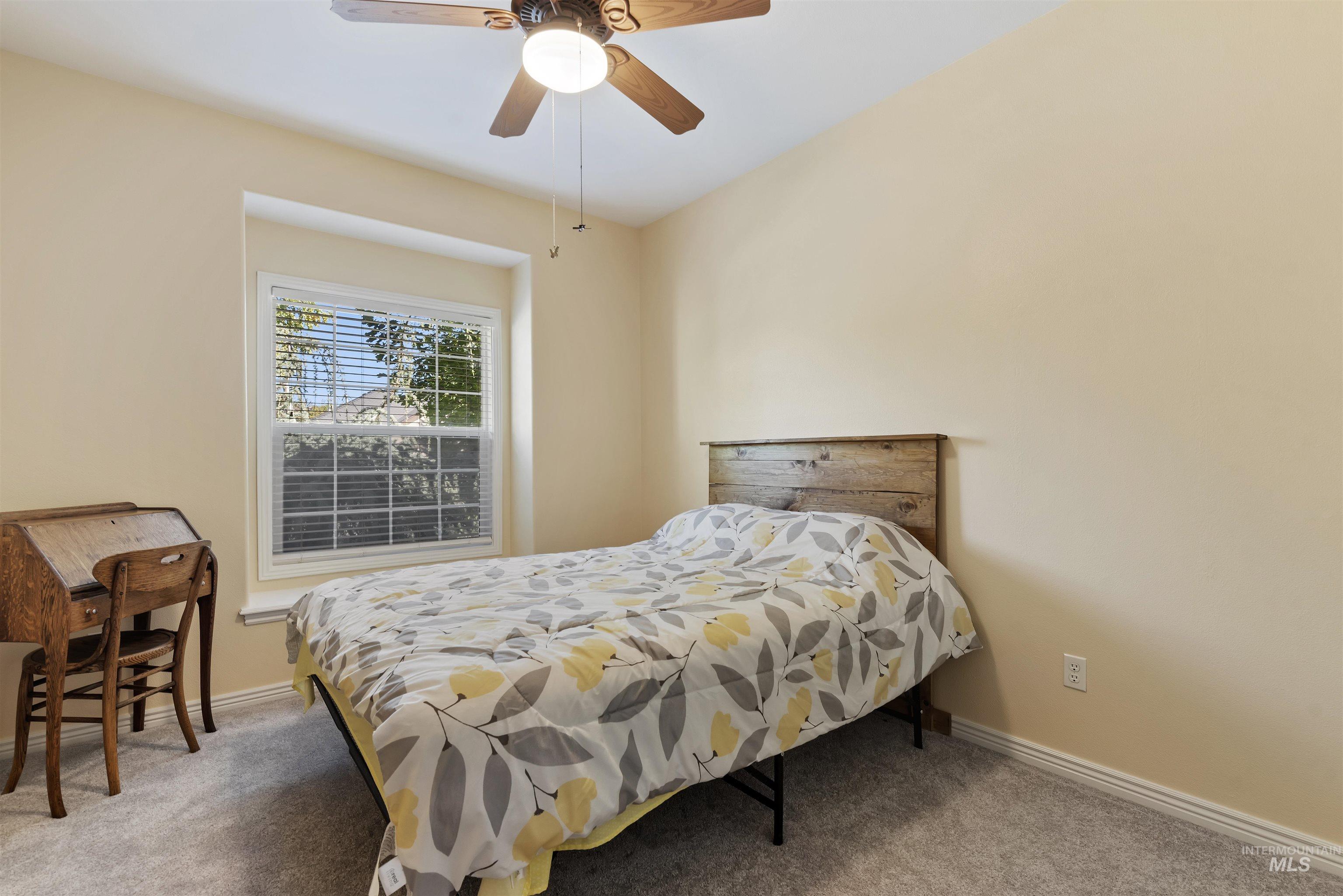 Bedroom featuring carpet and ceiling fan