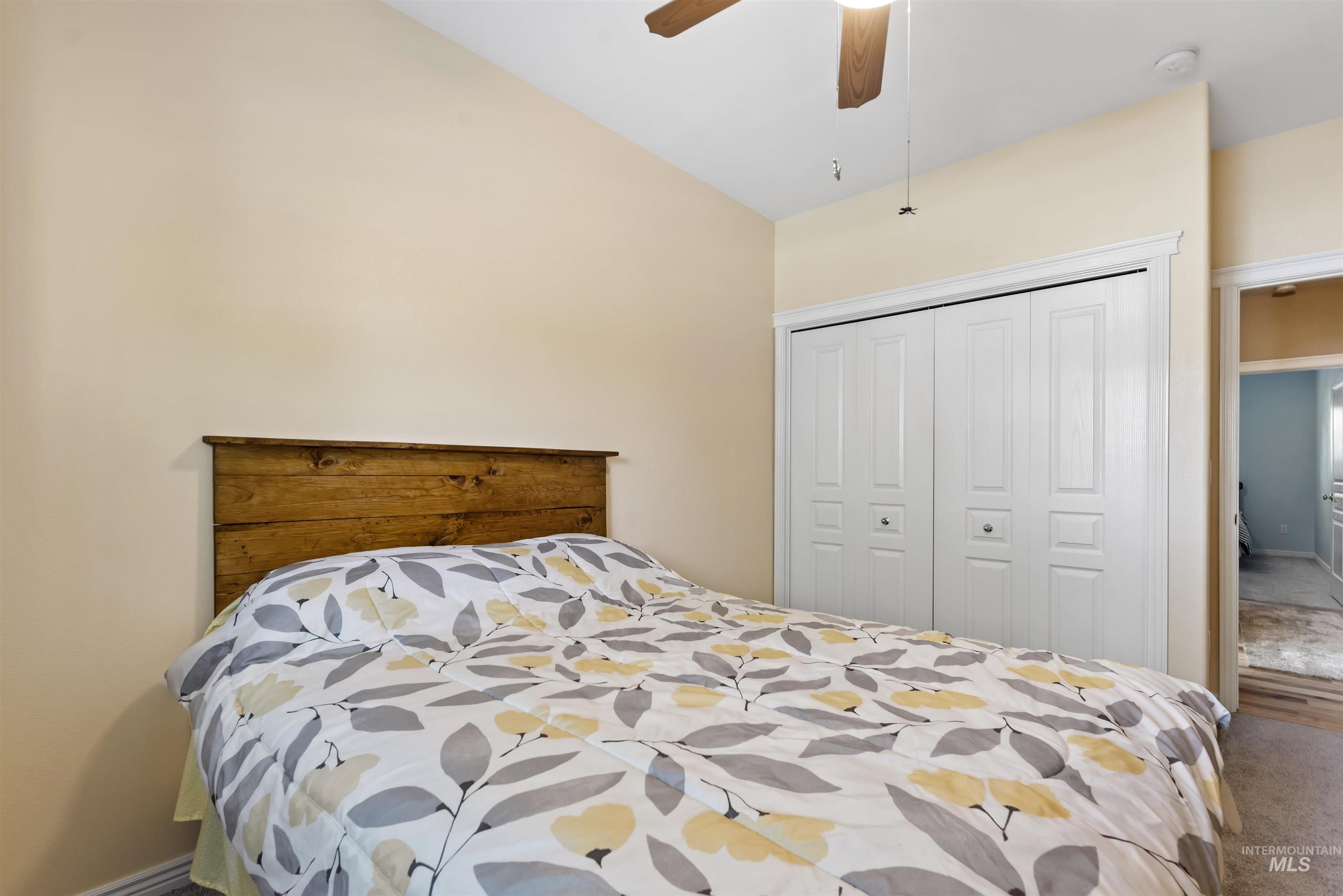 Carpeted bedroom featuring a closet and ceiling fan