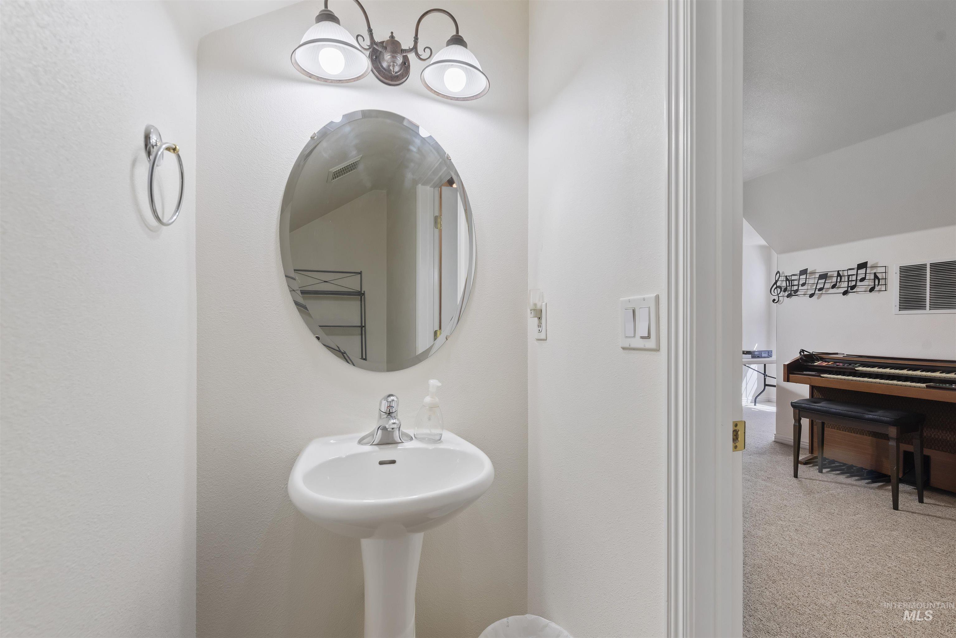 Bathroom featuring lofted ceiling