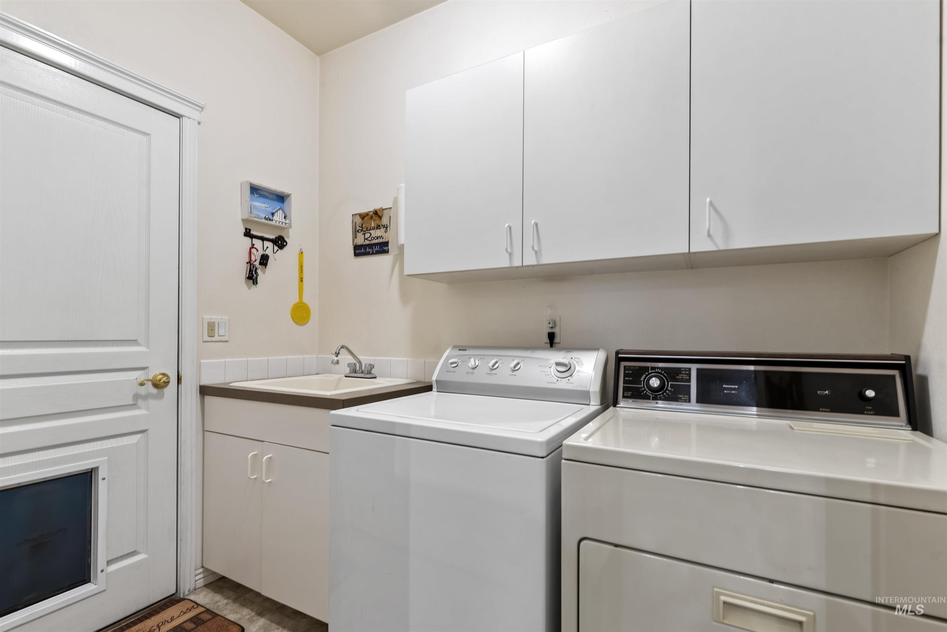 Laundry room with cabinet space and washer and dryer