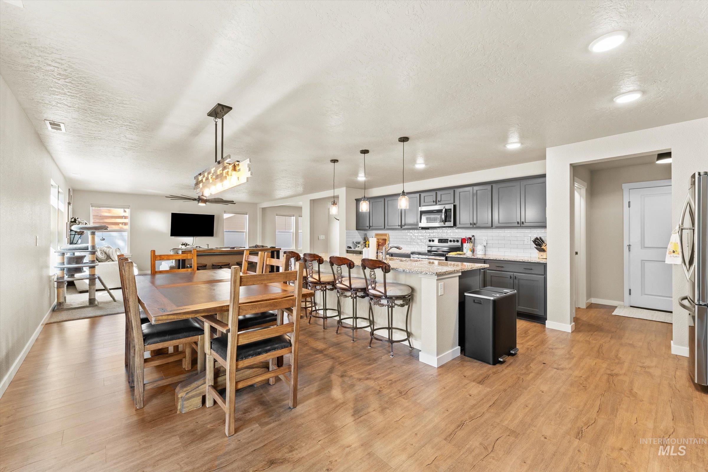 Dining room featuring a textured ceiling and light wood-style floors
