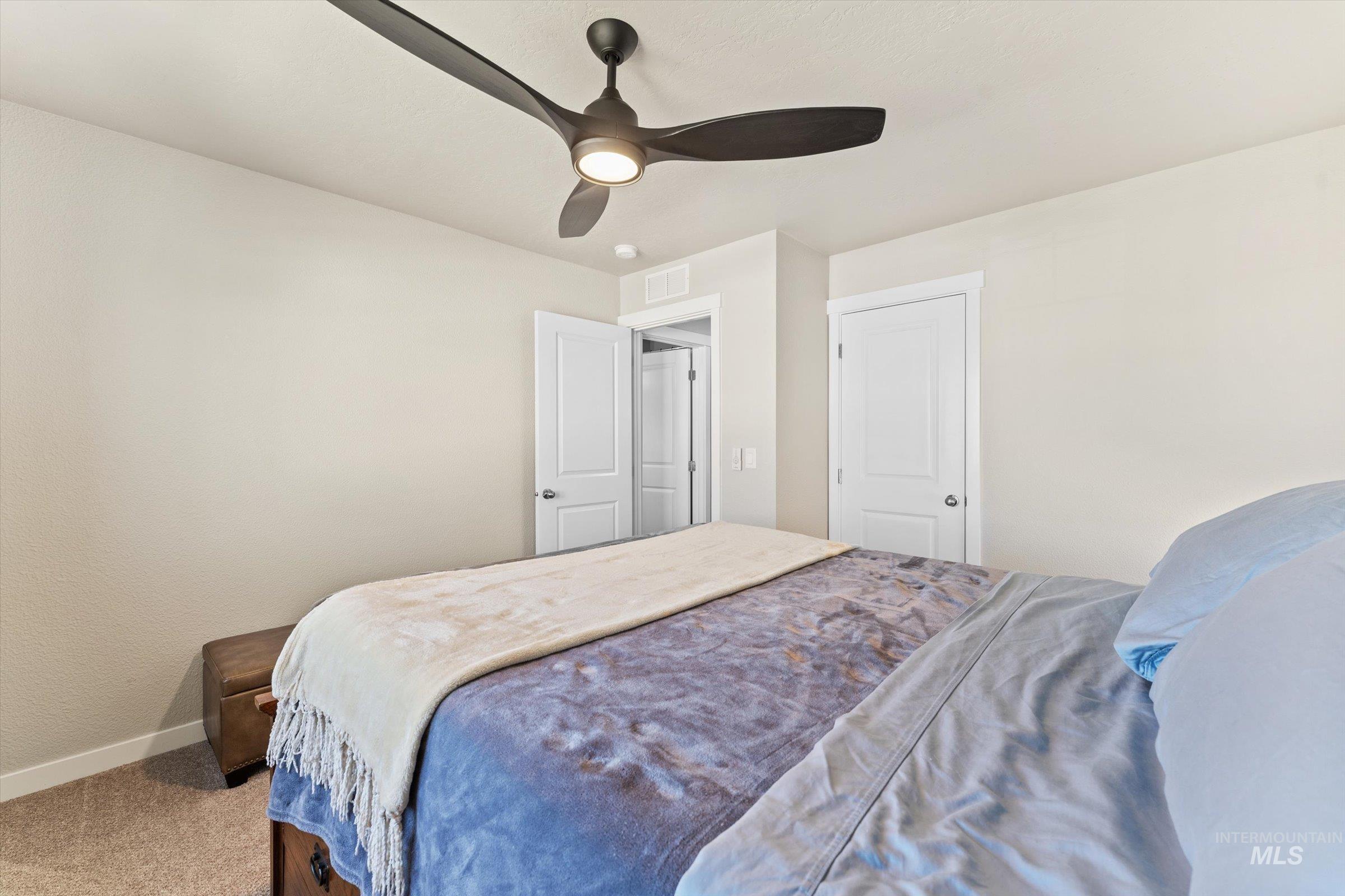 Bedroom featuring ceiling fan and carpet floors