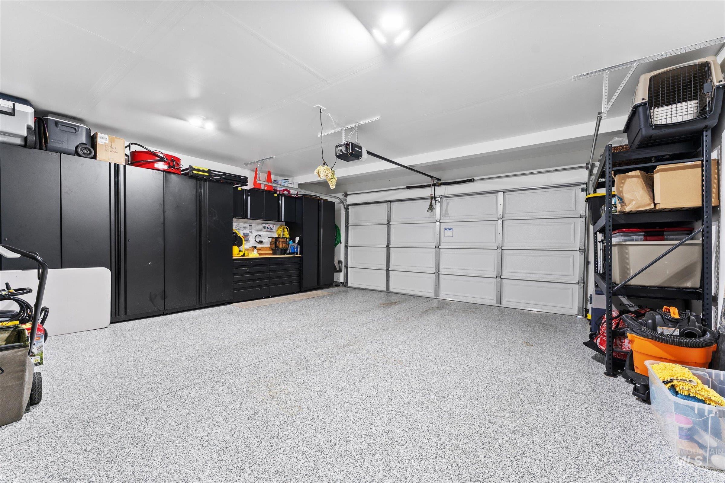 Garage featuring cabinets and polyurea floors.