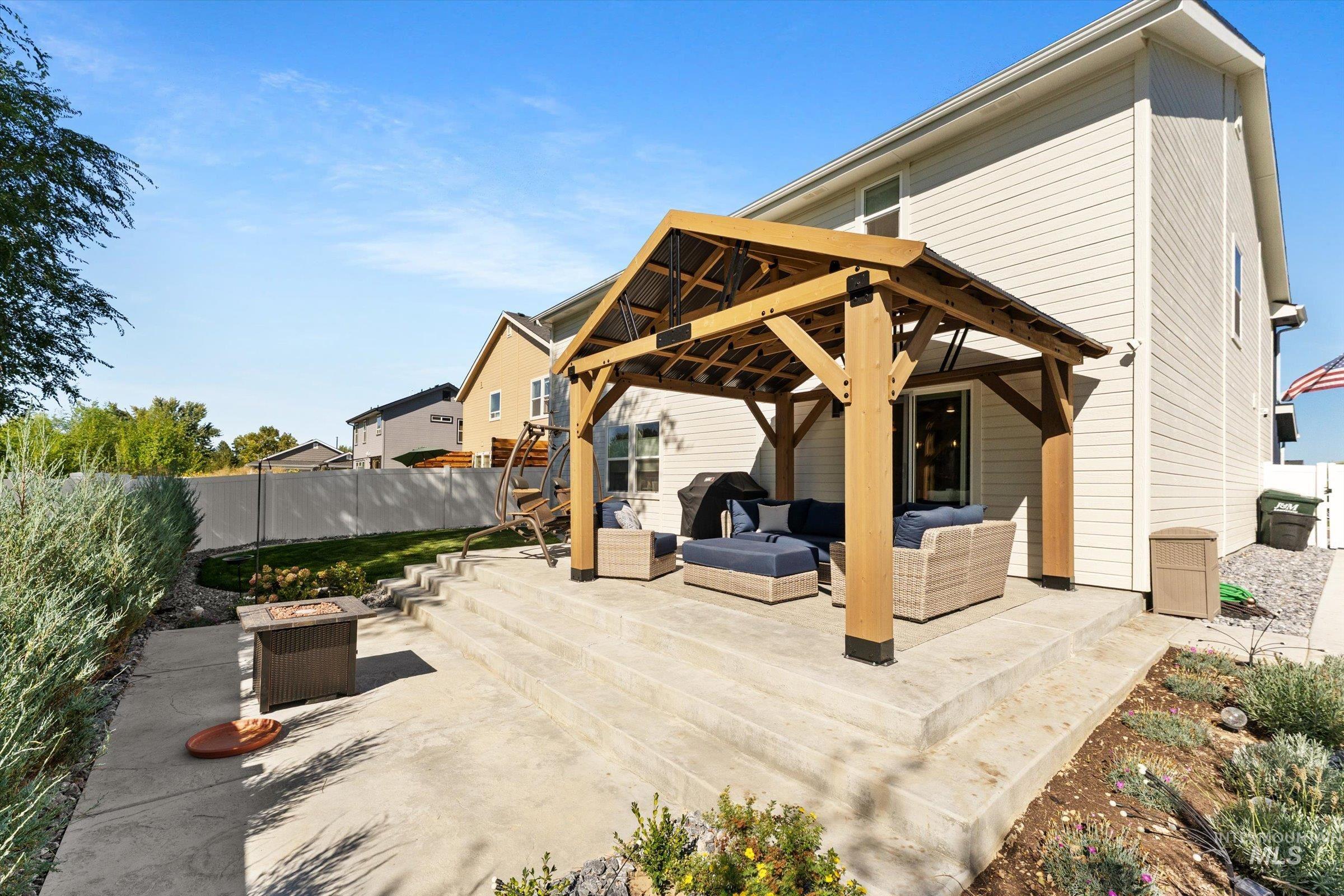 View of patio / terrace with an outdoor living space with a fire pit, grilling area, and a gazebo