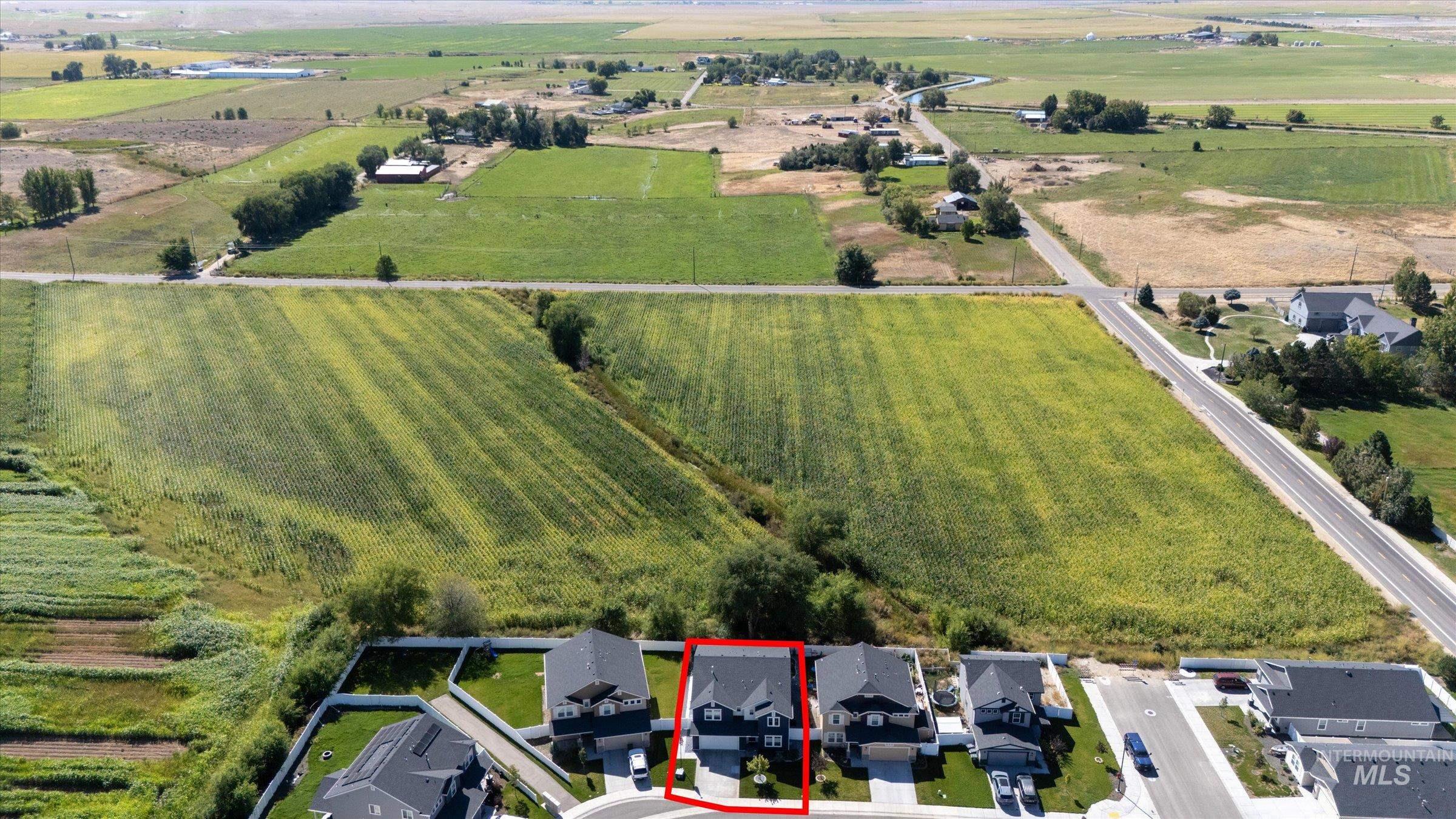 View of rural area with property parcel outlined (estimated) and nearby suburban area