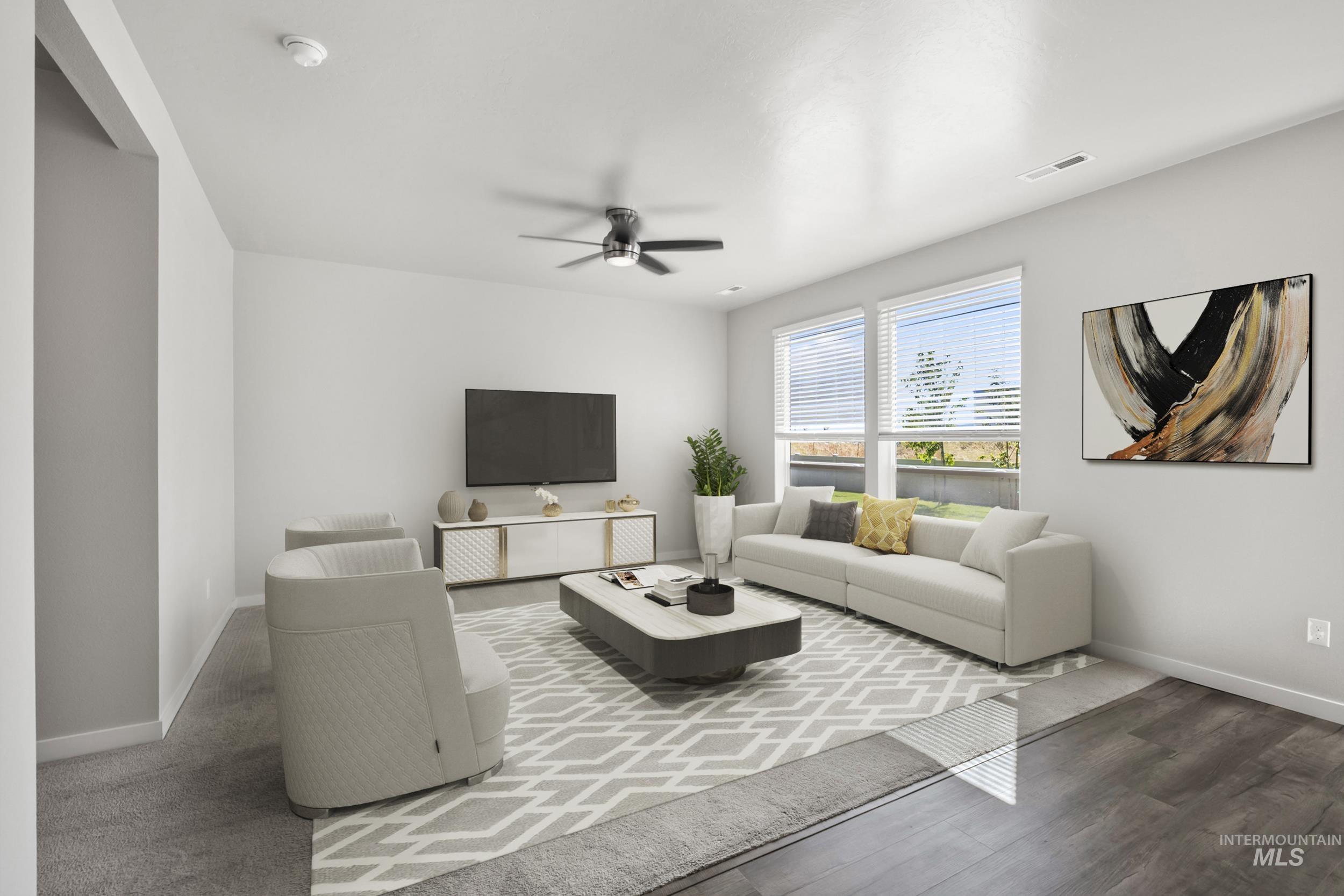 Living room with ceiling fan and wood finished floors
