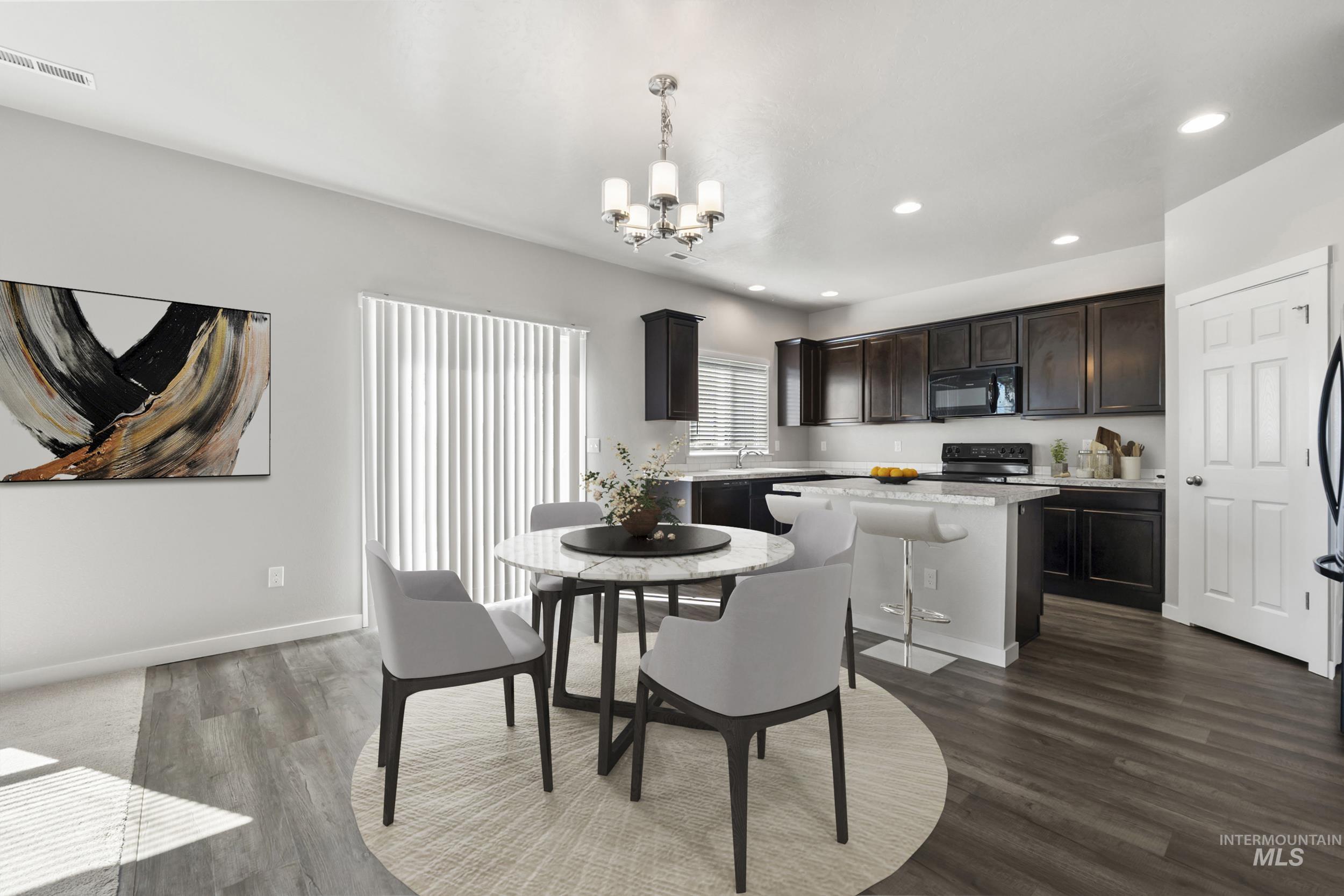 Dining space featuring recessed lighting, dark wood-type flooring, and a chandelier