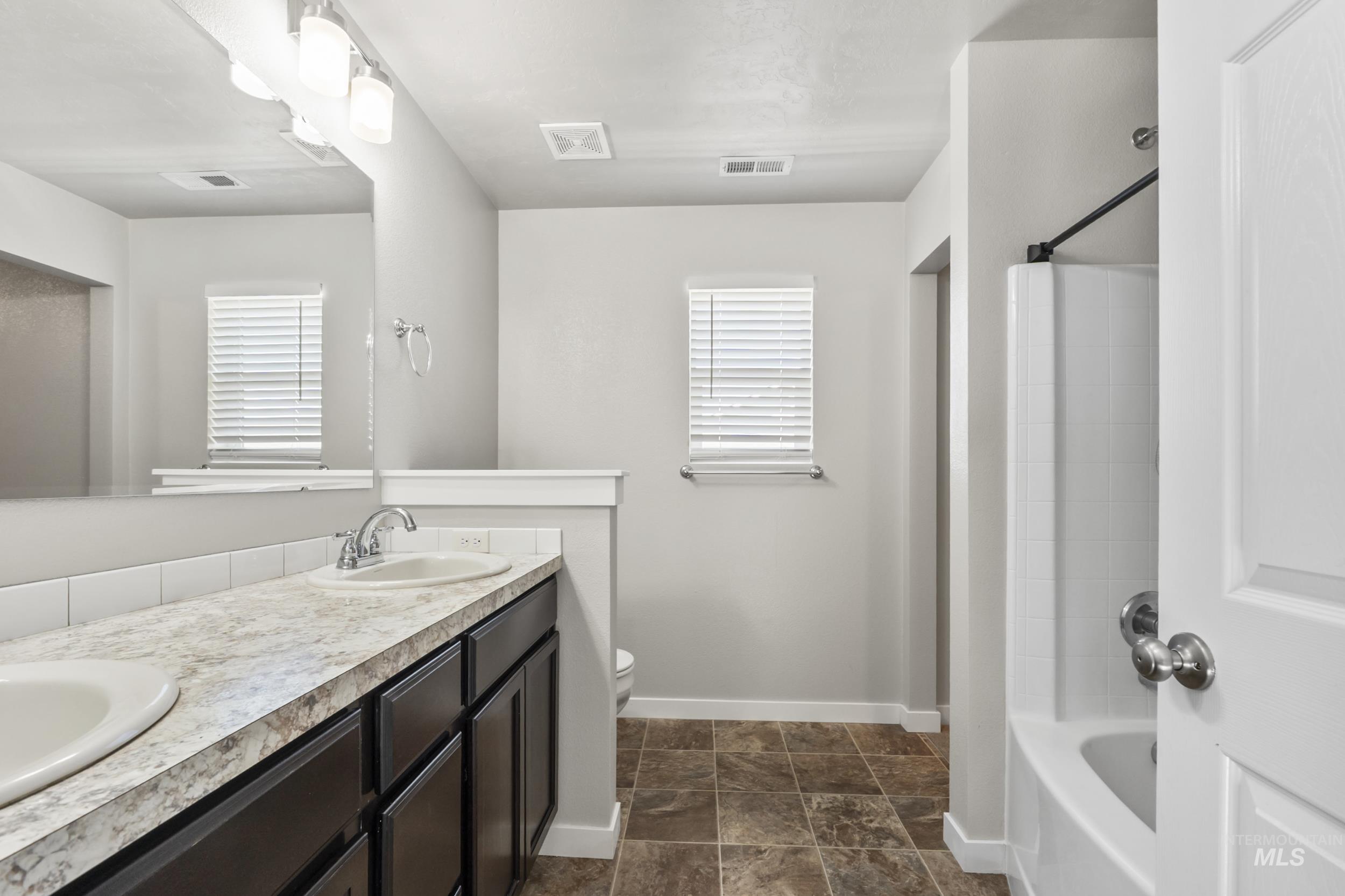 Full bath with double vanity and  shower combination