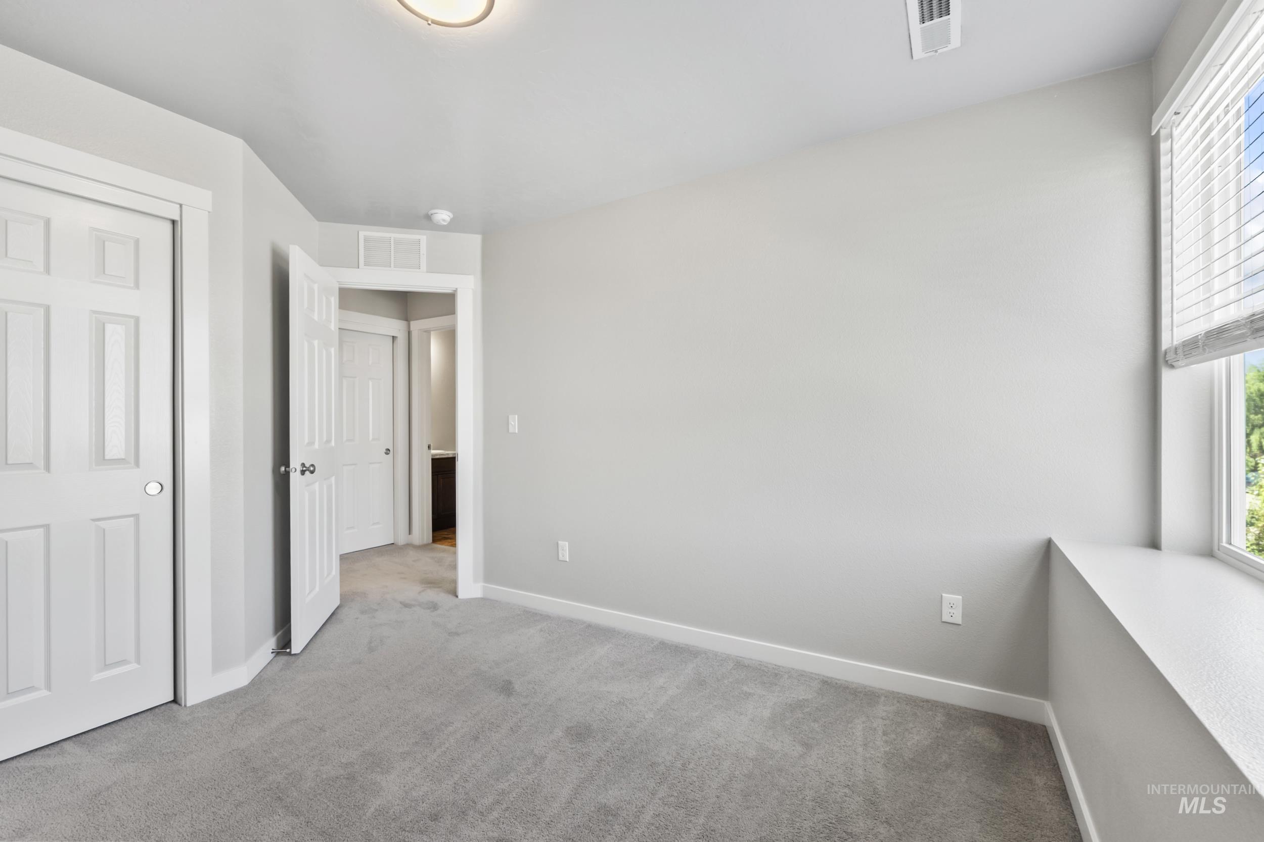 Unfurnished bedroom with carpet floors and a closet