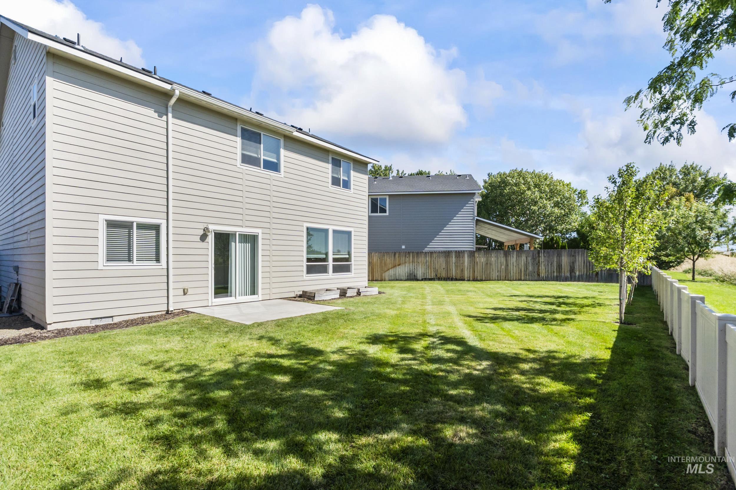Rear view of property with a patio and a fenced backyard