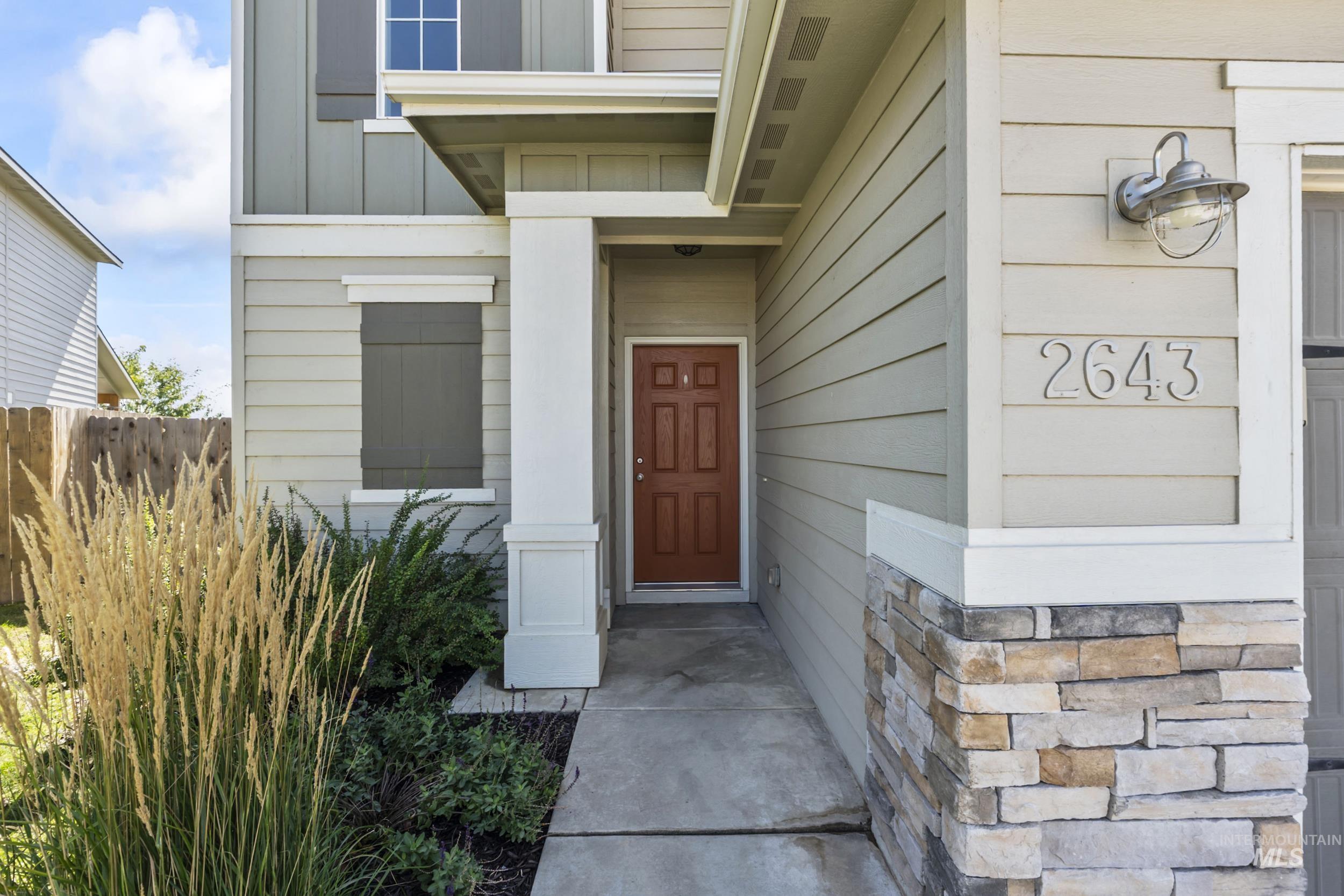 Entrance to property featuring stone siding