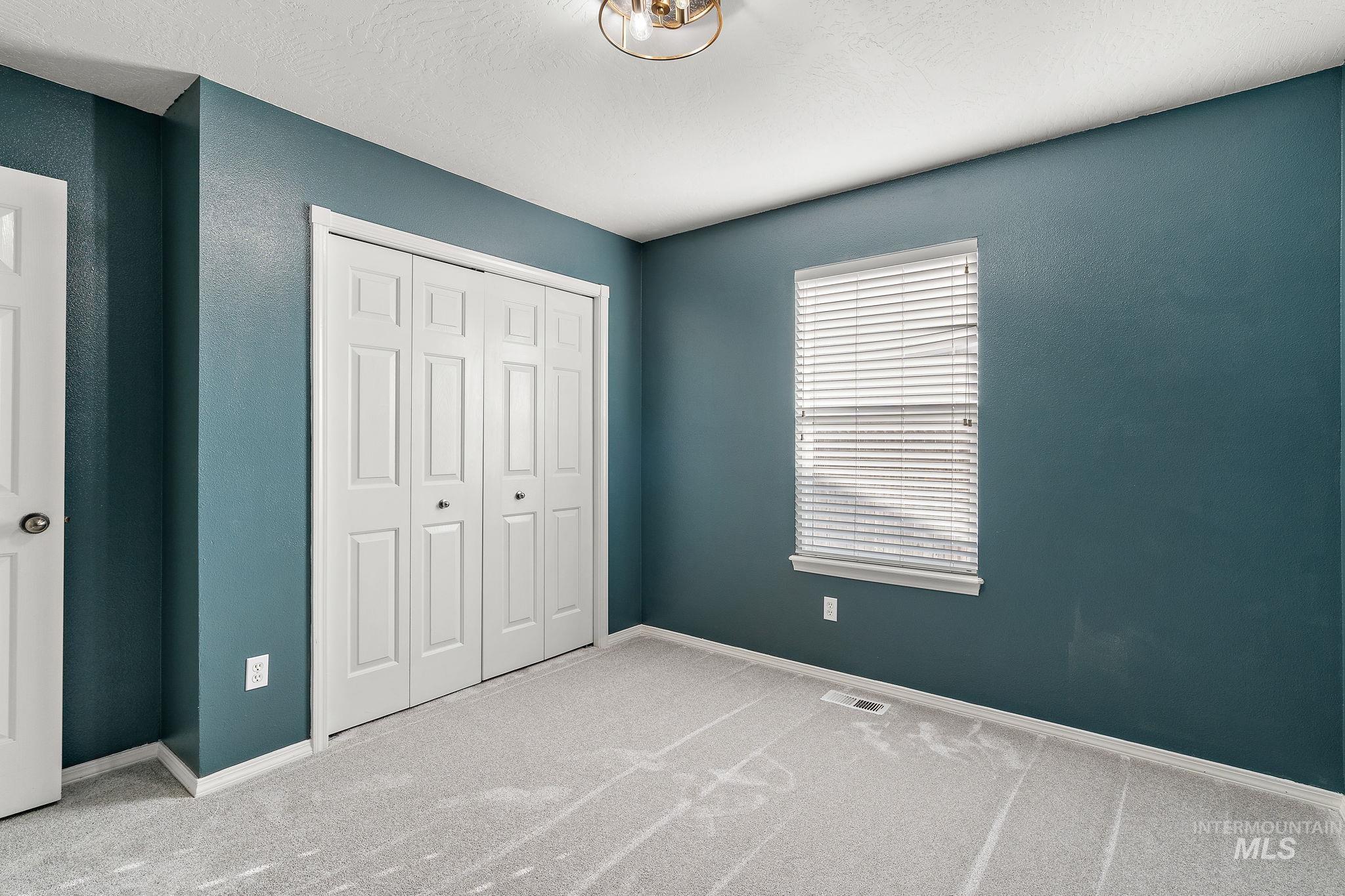 Unfurnished bedroom featuring carpet floors and a closet