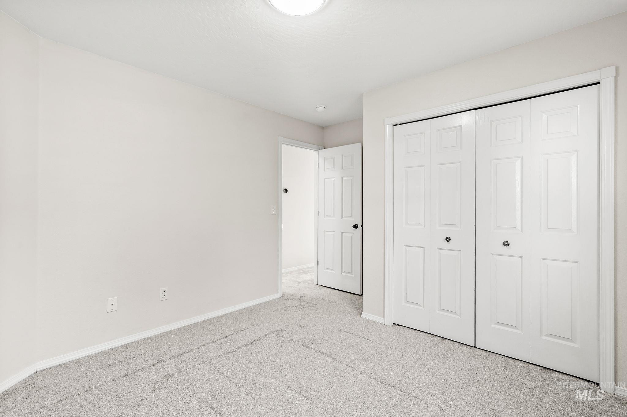 Unfurnished bedroom featuring carpet and a closet
