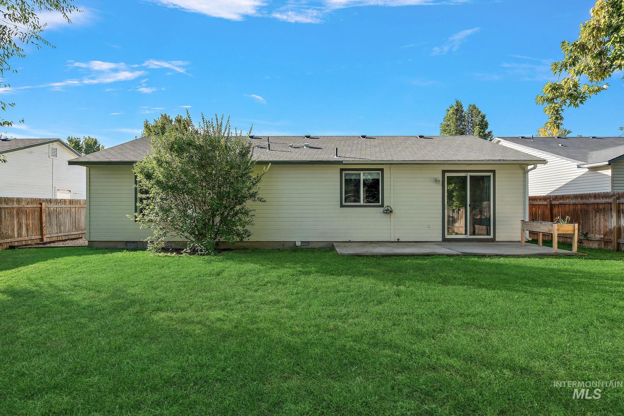Rear view of property featuring a patio, a shingled roof, and crawl space