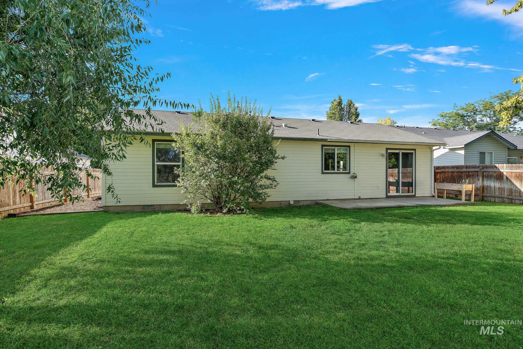 Rear view of house featuring a fenced backyard, a patio, crawl space, and roof with shingles