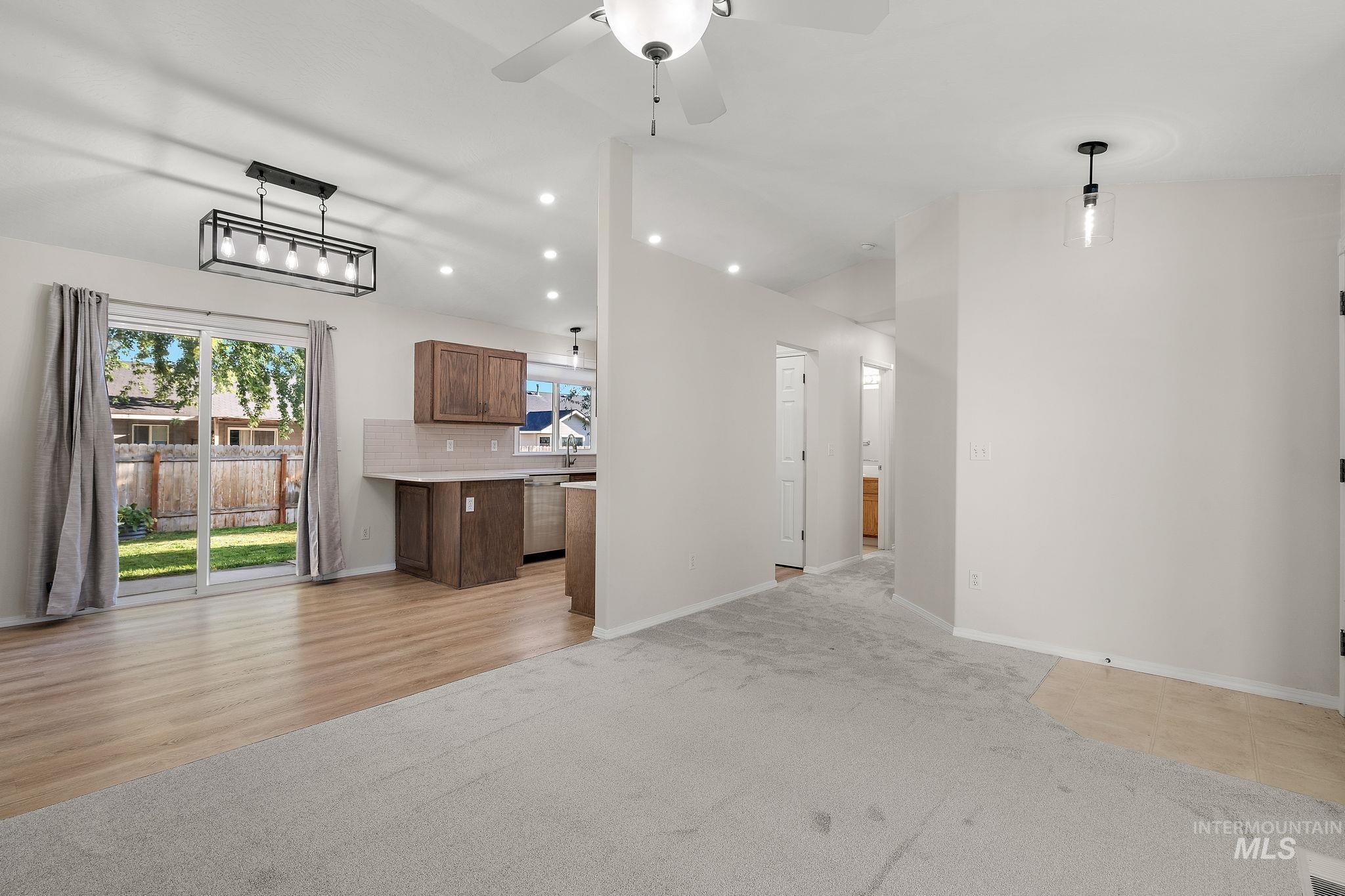 Unfurnished living room with recessed lighting, ceiling fan, light carpet, and light wood finished floors