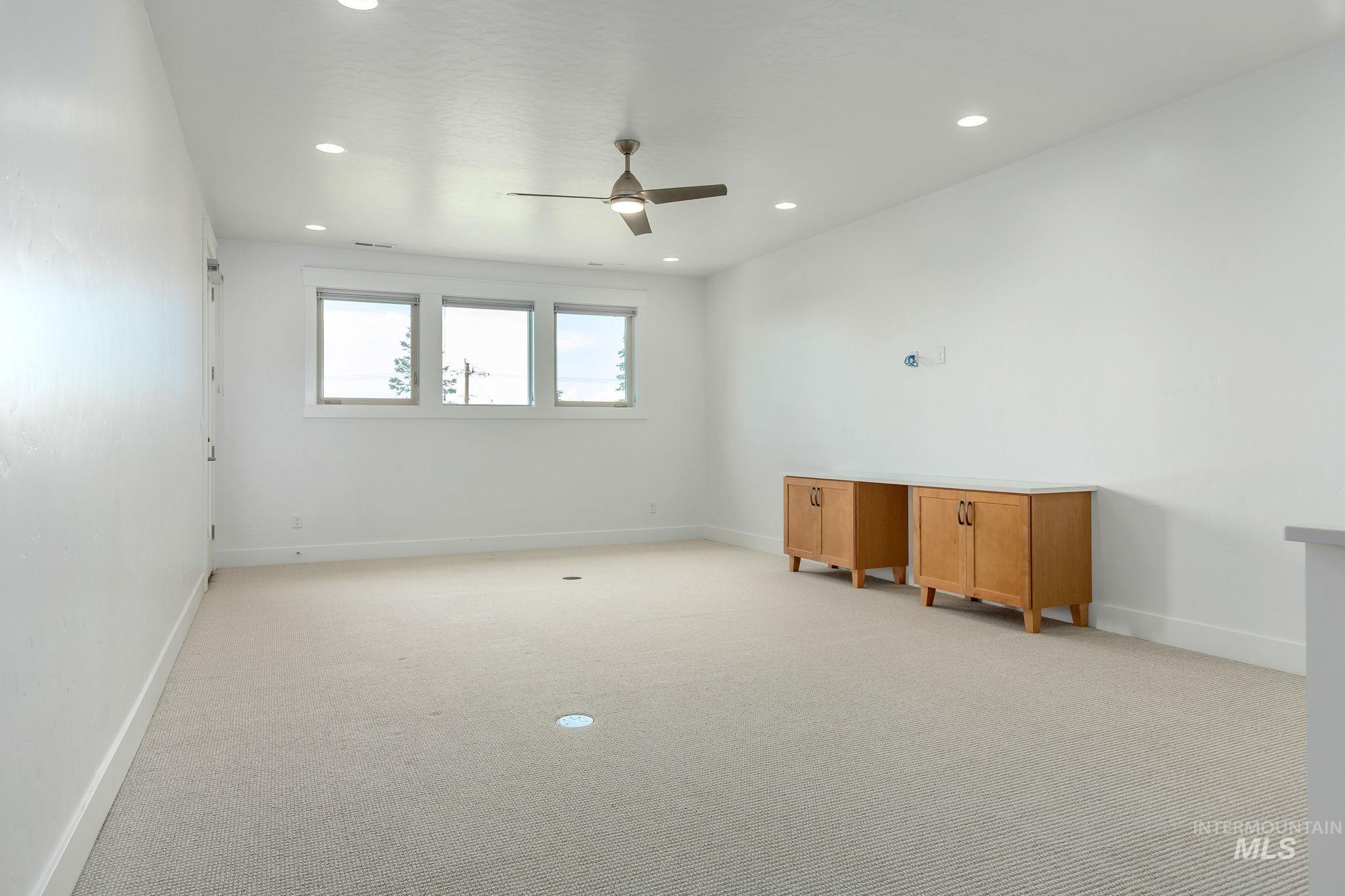 Empty room with light carpet, recessed lighting, and a ceiling fan