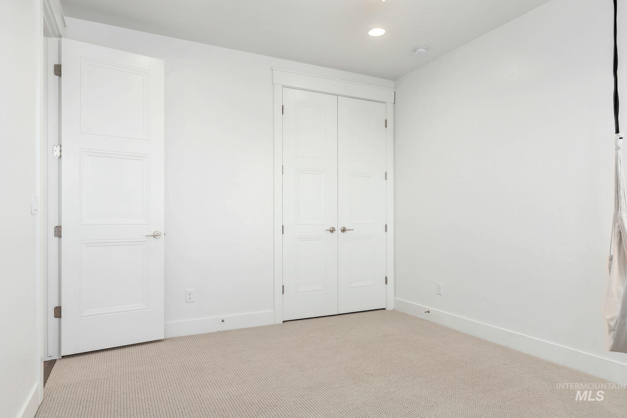 Unfurnished bedroom featuring carpet, recessed lighting, and a closet
