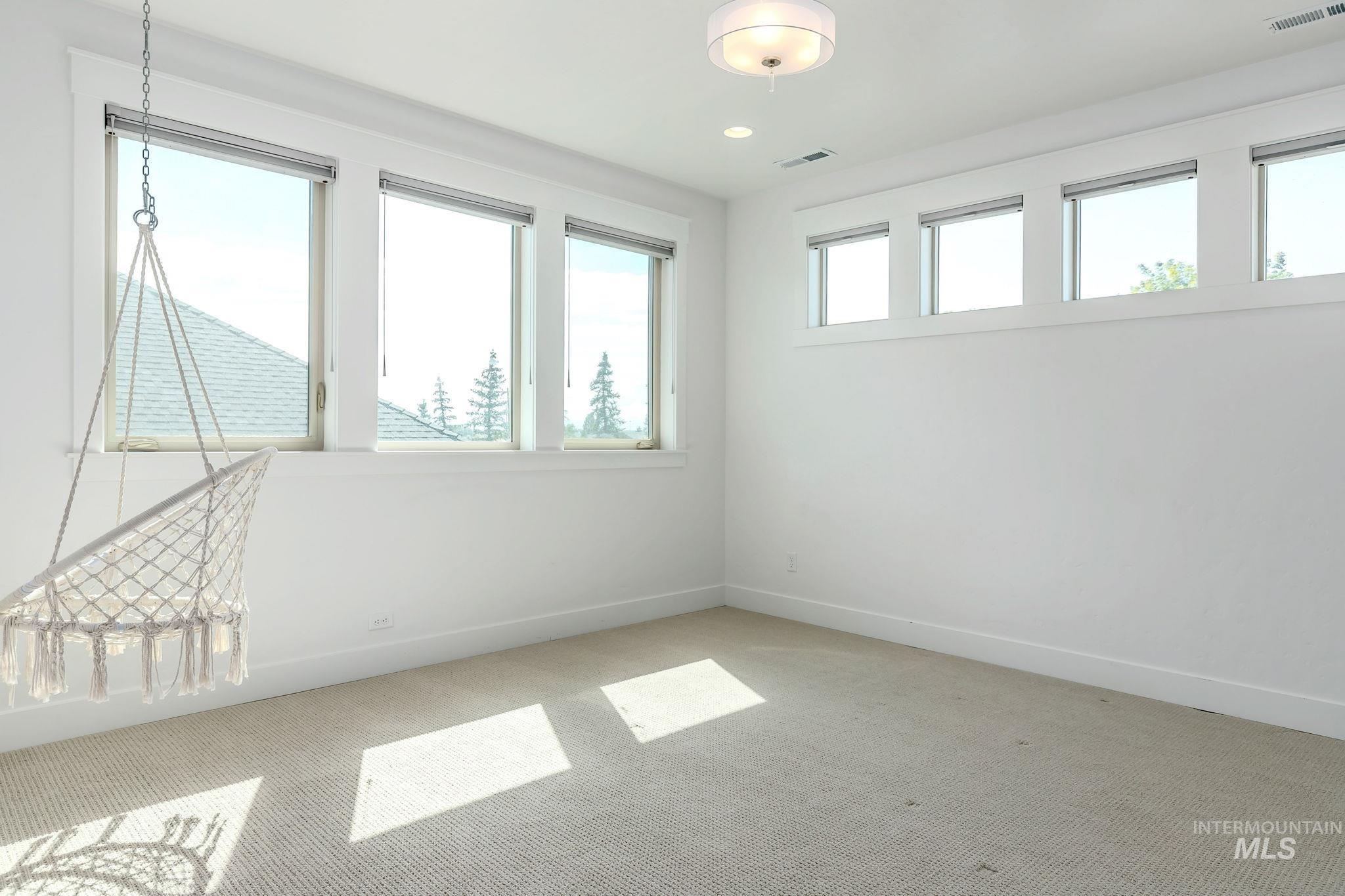 Empty room with carpet and recessed lighting
