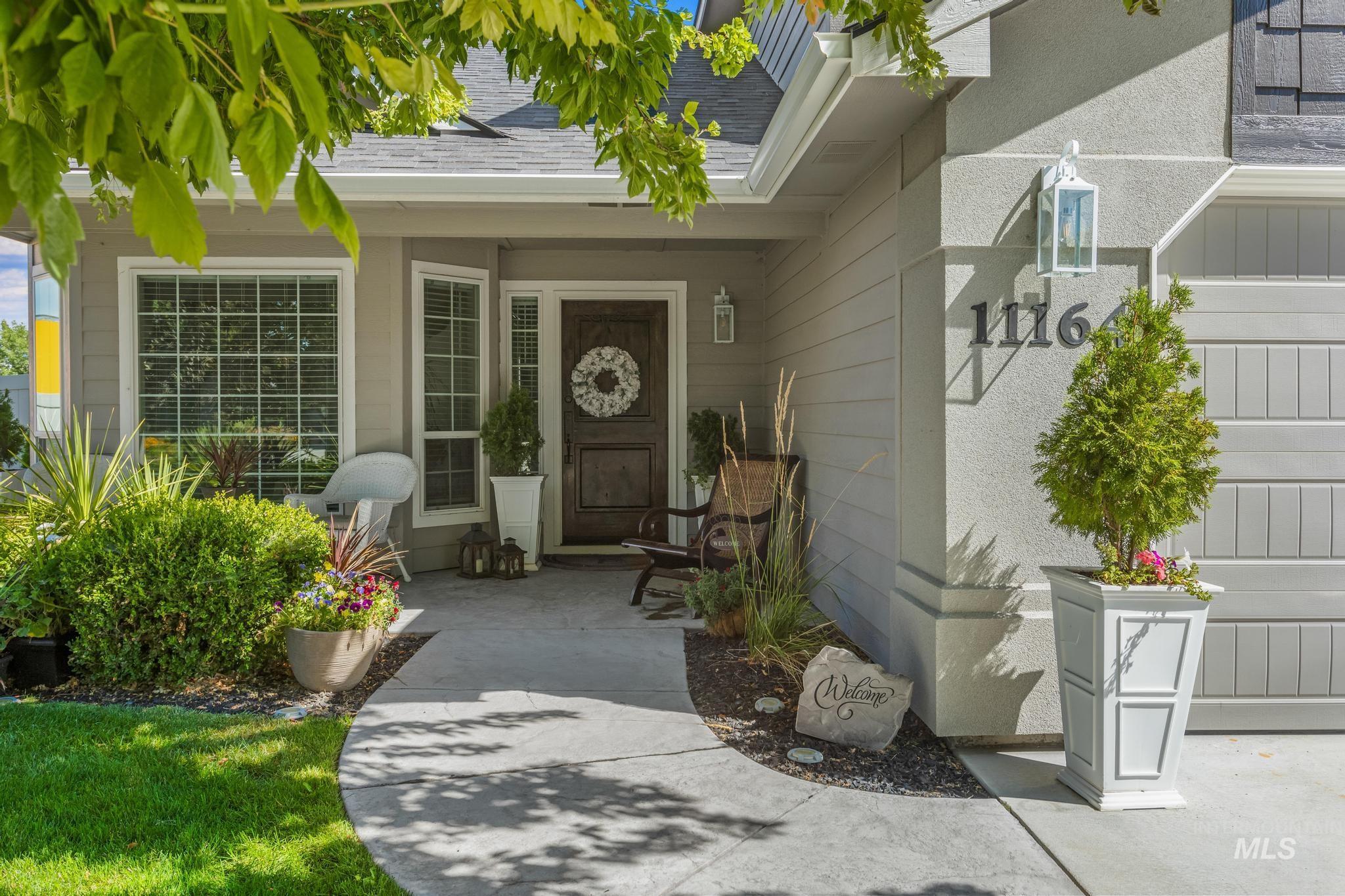 Doorway to property with a shingled roof