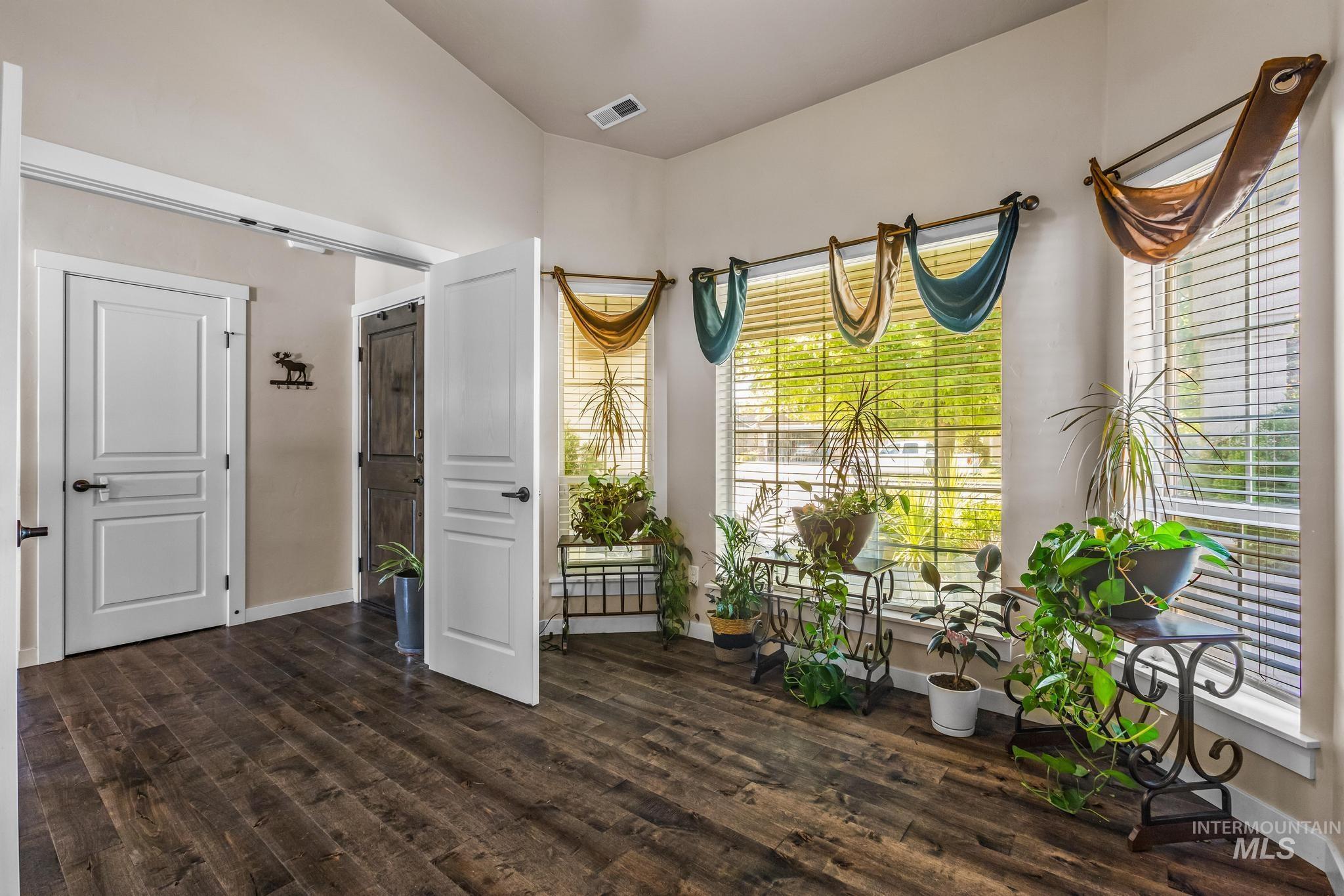 Dining area featuring dark wood finished floors and baseboards