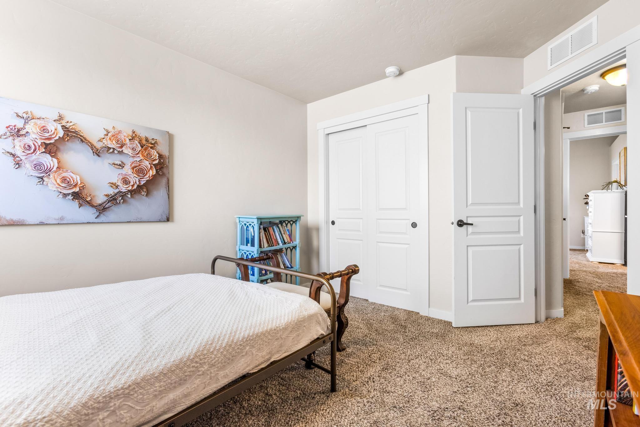 Bedroom with carpet and a closet