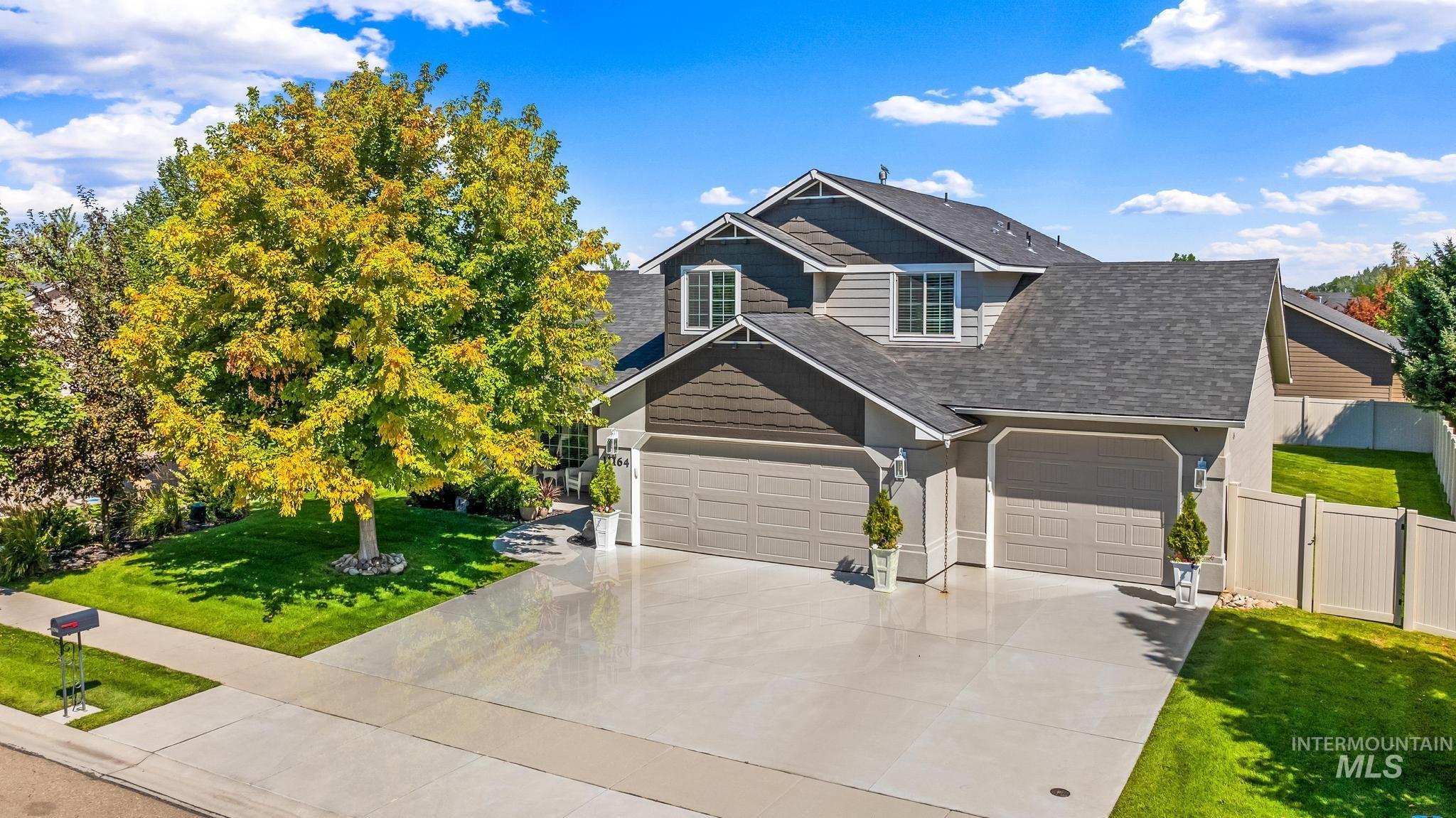 View of front of home featuring roof with shingles, concrete driveway, and a garage