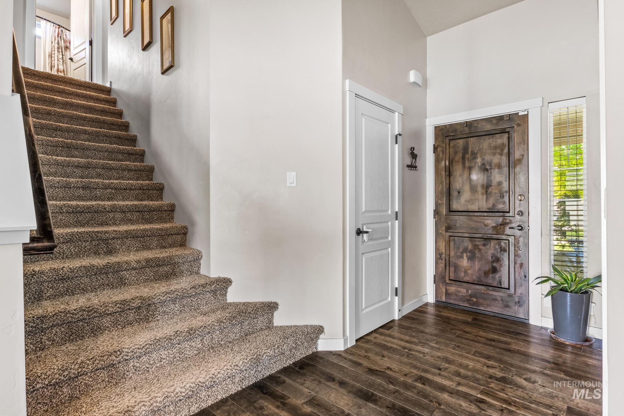 Entrance foyer featuring dark wood-style floors and stairway