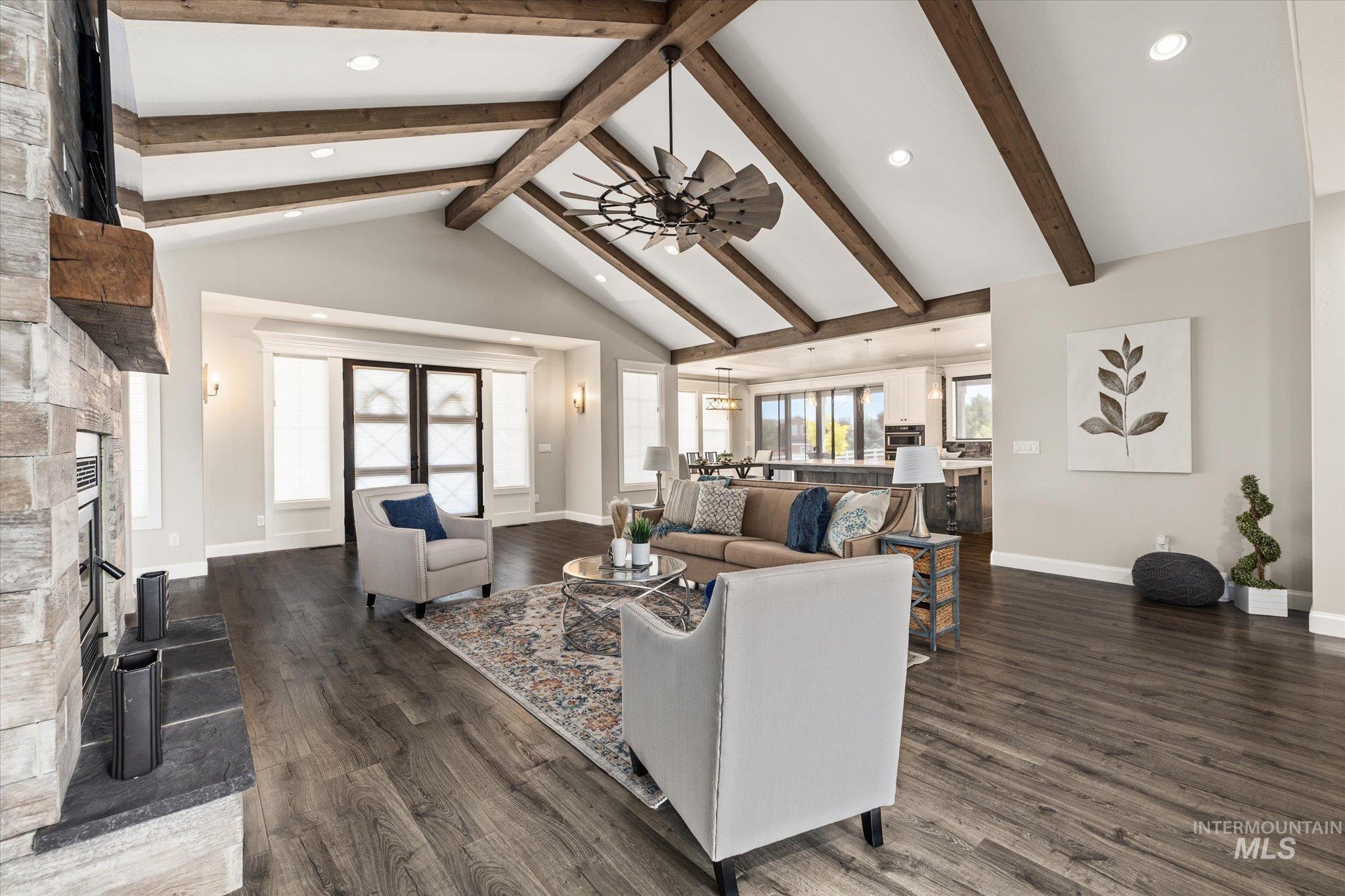 Living area featuring a fireplace, recessed lighting, dark wood finished floors, and a ceiling fan