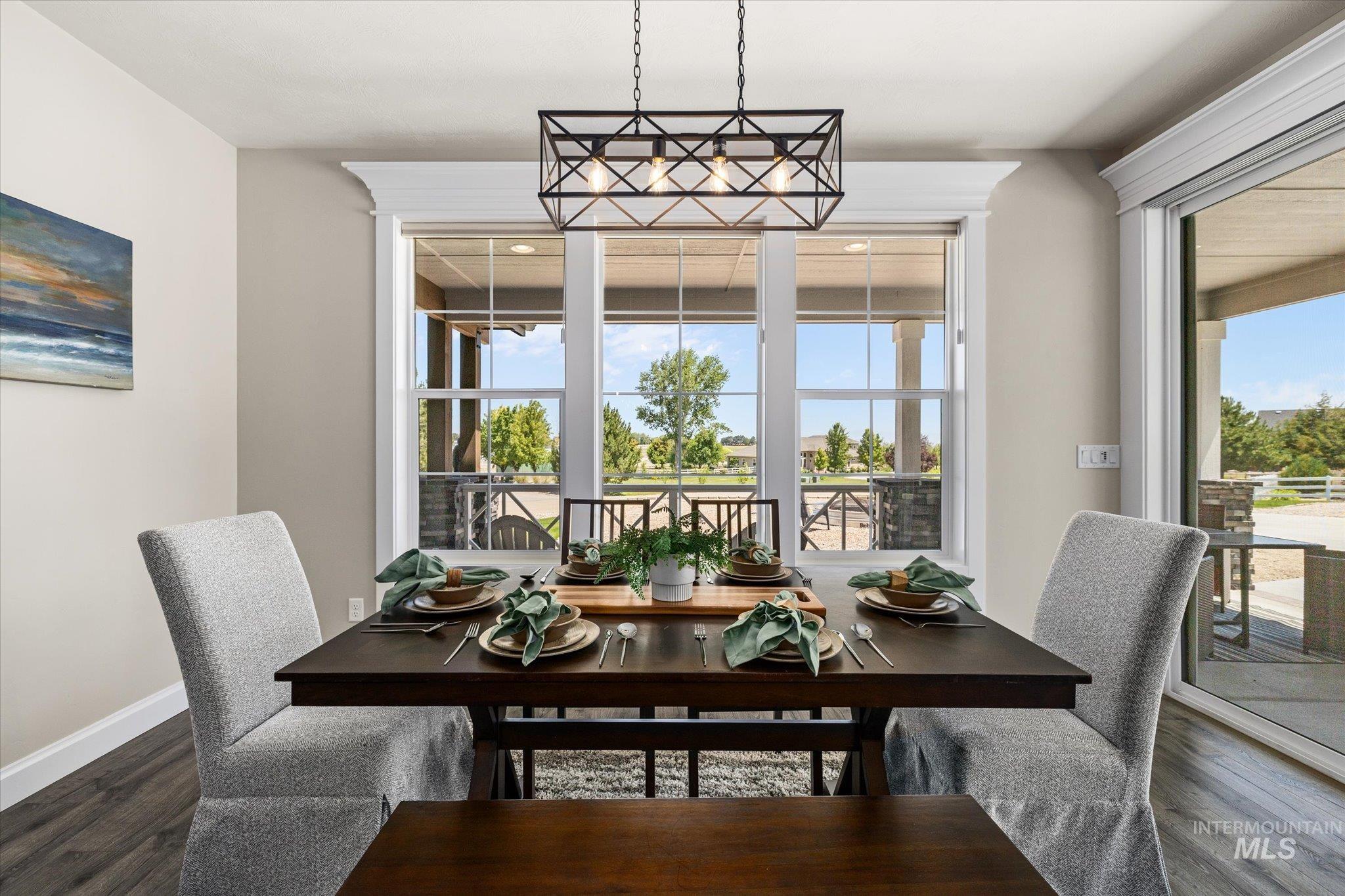 Dining area with dark wood finished floors and baseboards