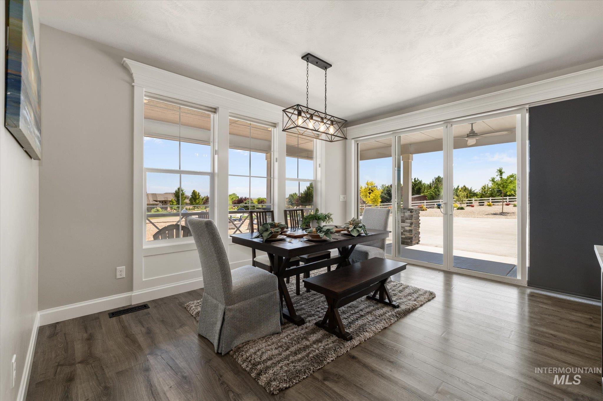Dining room featuring plenty of natural light and dark wood-type flooring