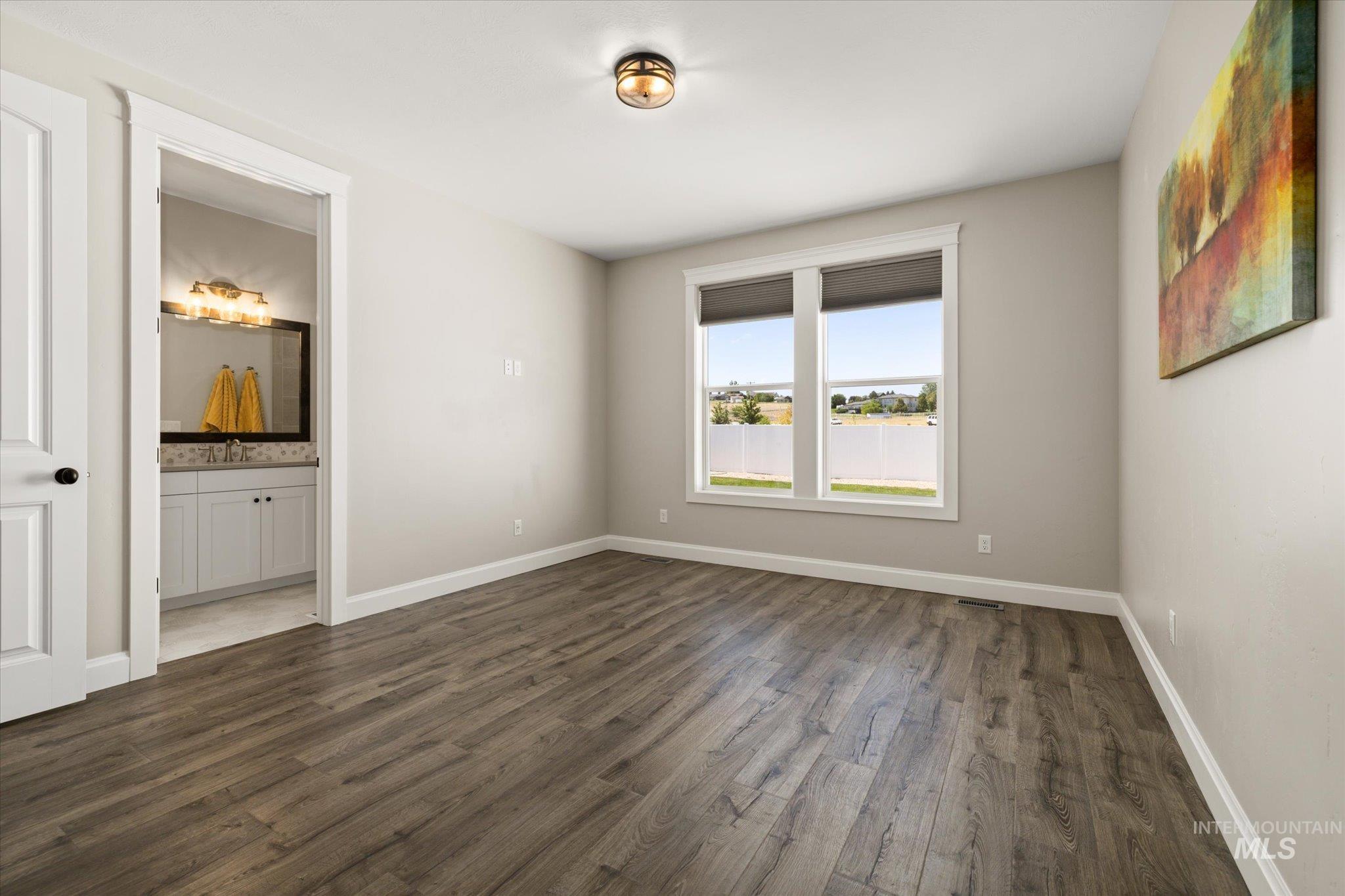 Empty room featuring dark wood-type flooring