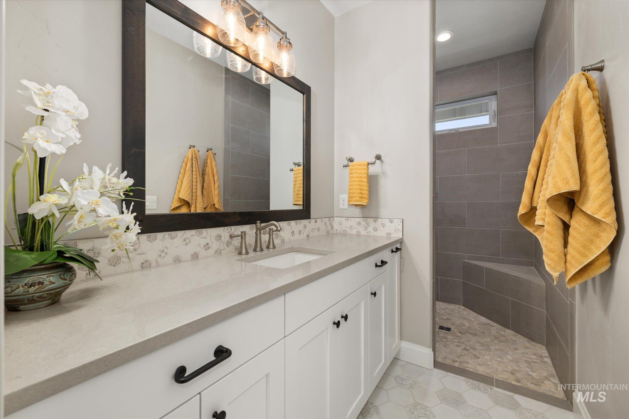 Bathroom with vanity, walk in shower, recessed lighting, and tile patterned flooring