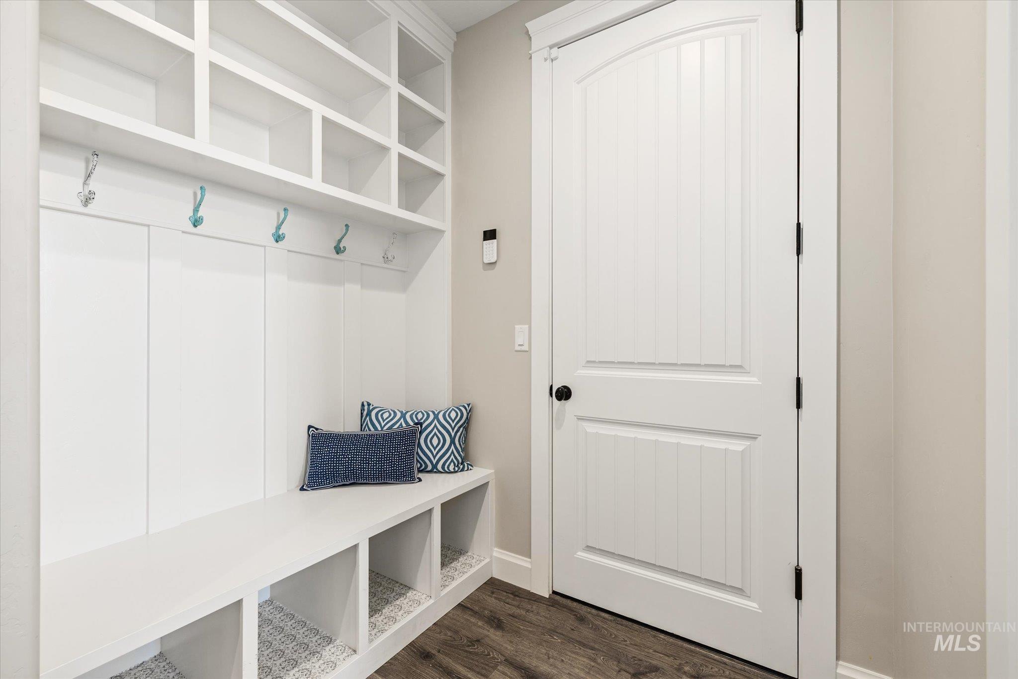 Mudroom with dark wood-style flooring and baseboards