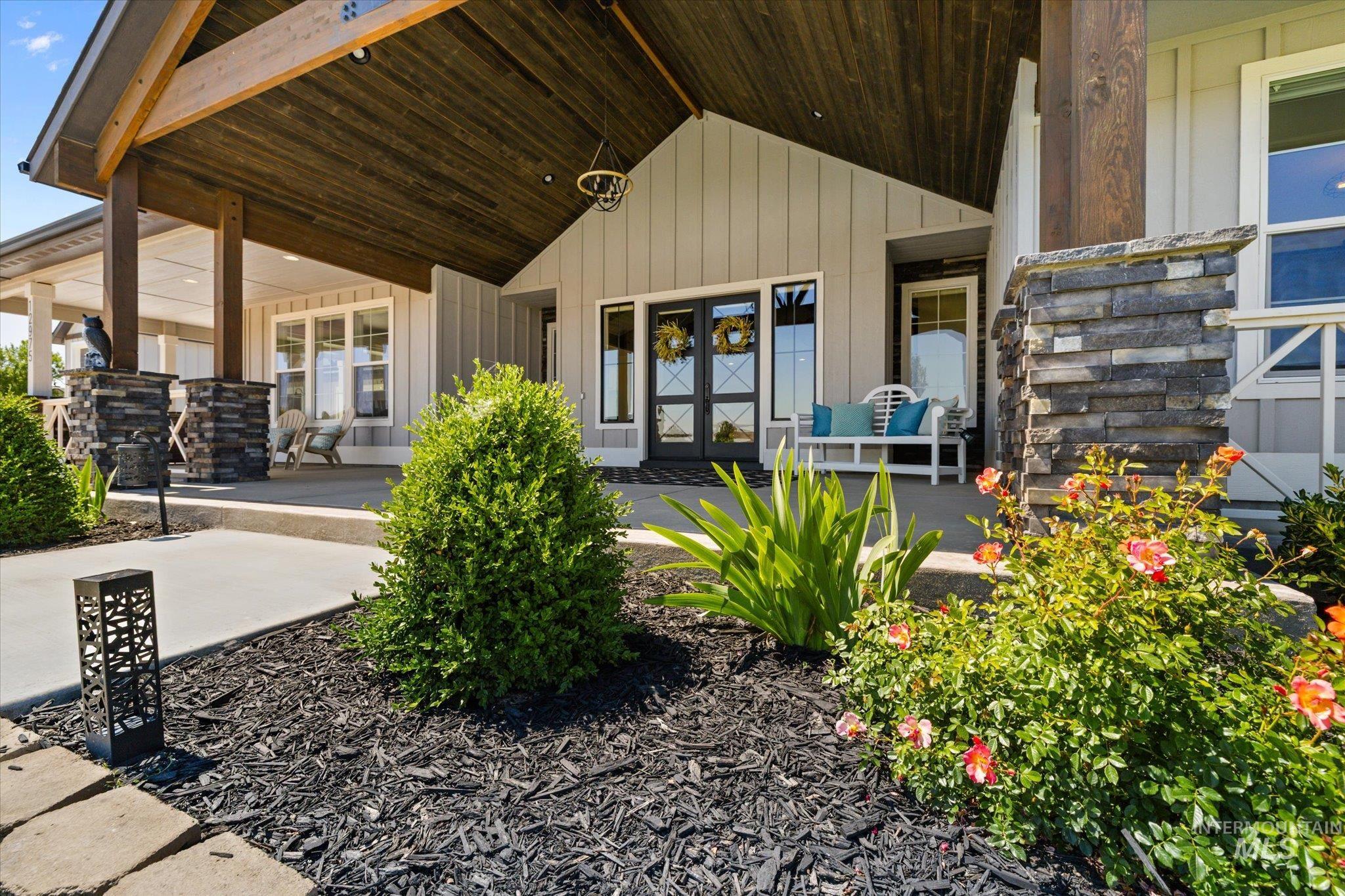Entrance to property featuring covered porch and board and batten siding