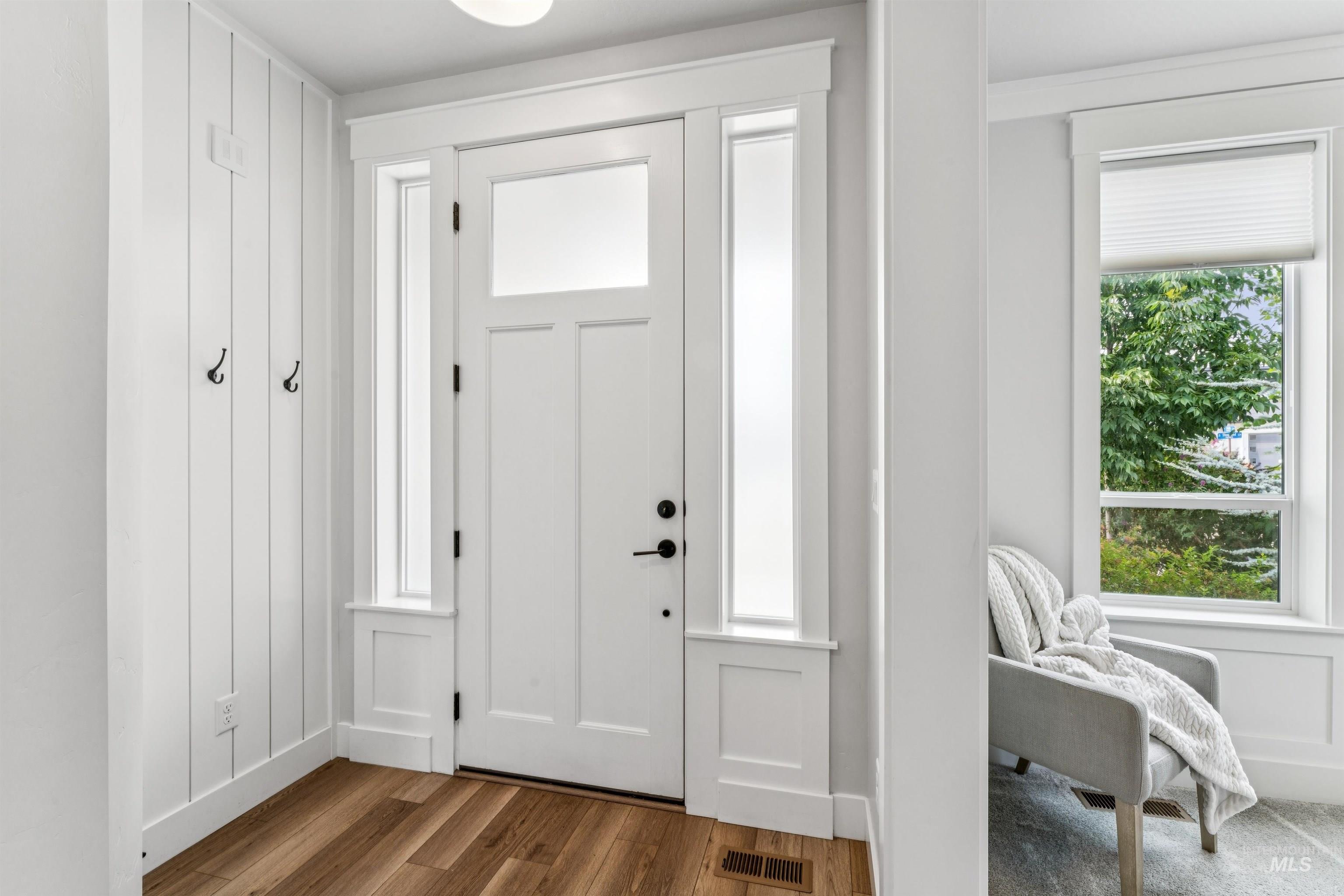Foyer entrance with wood finished floors