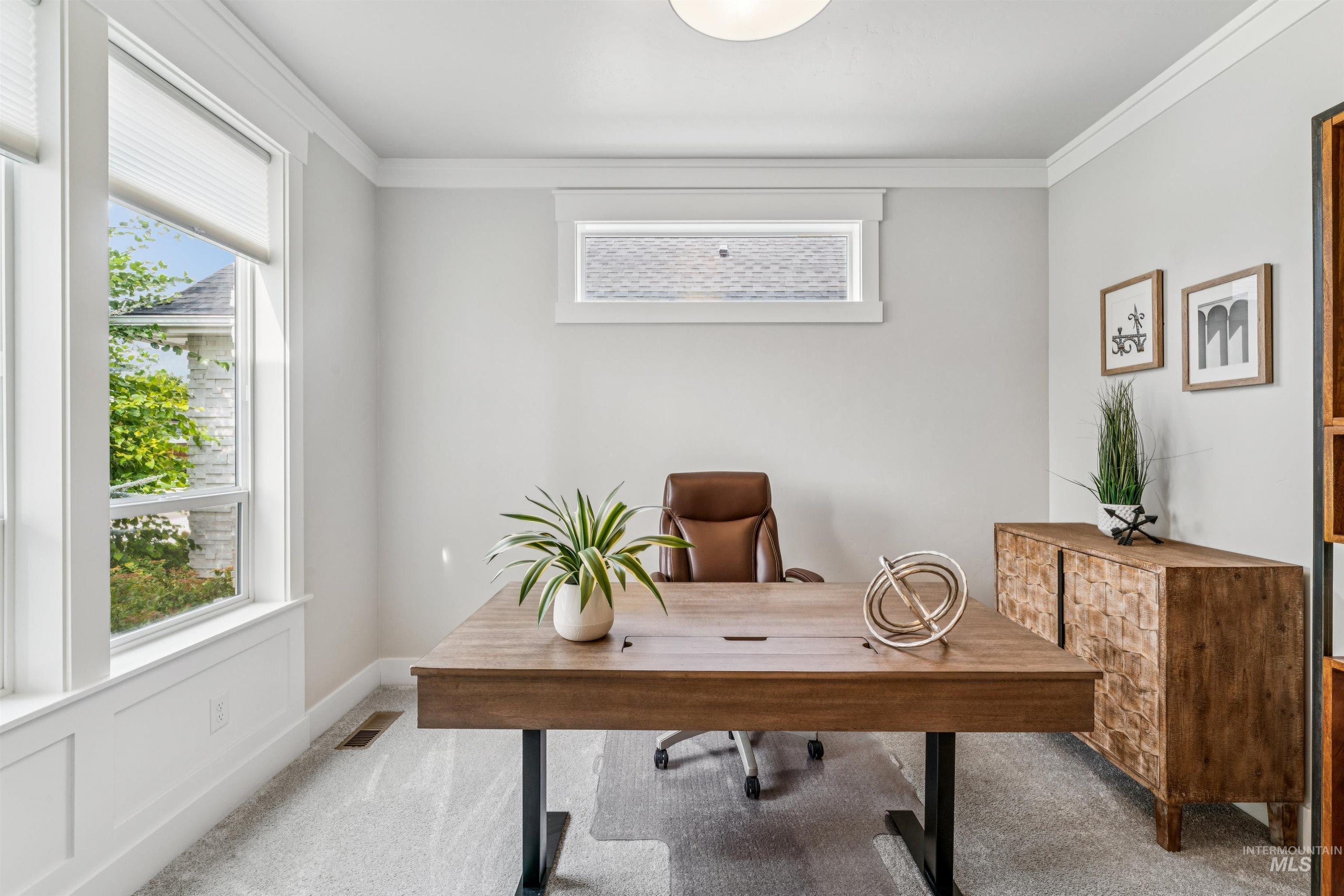 Office area featuring light colored carpet and ornamental molding