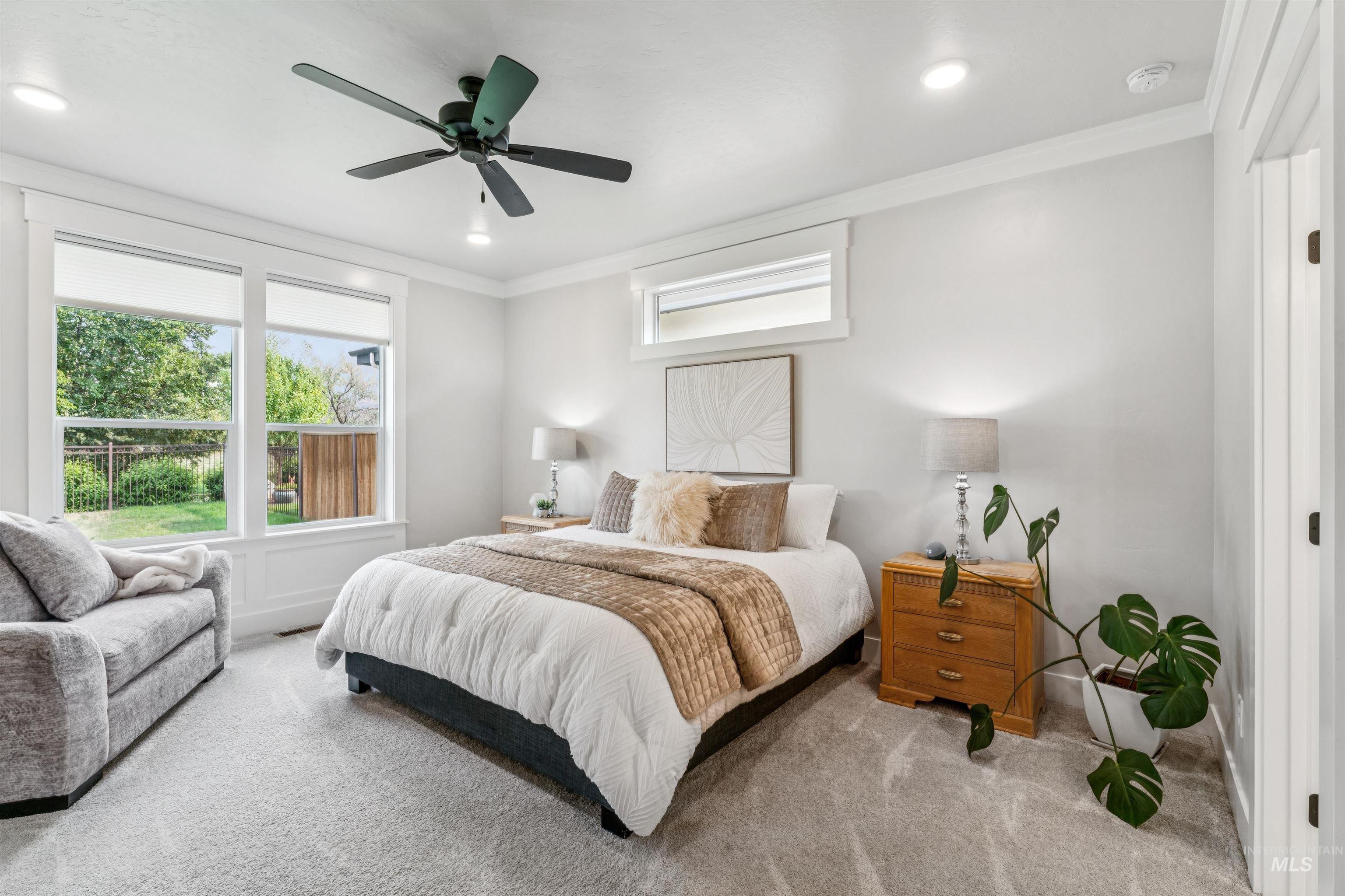 Bedroom with multiple windows, carpet flooring, crown molding, ceiling fan, and recessed lighting