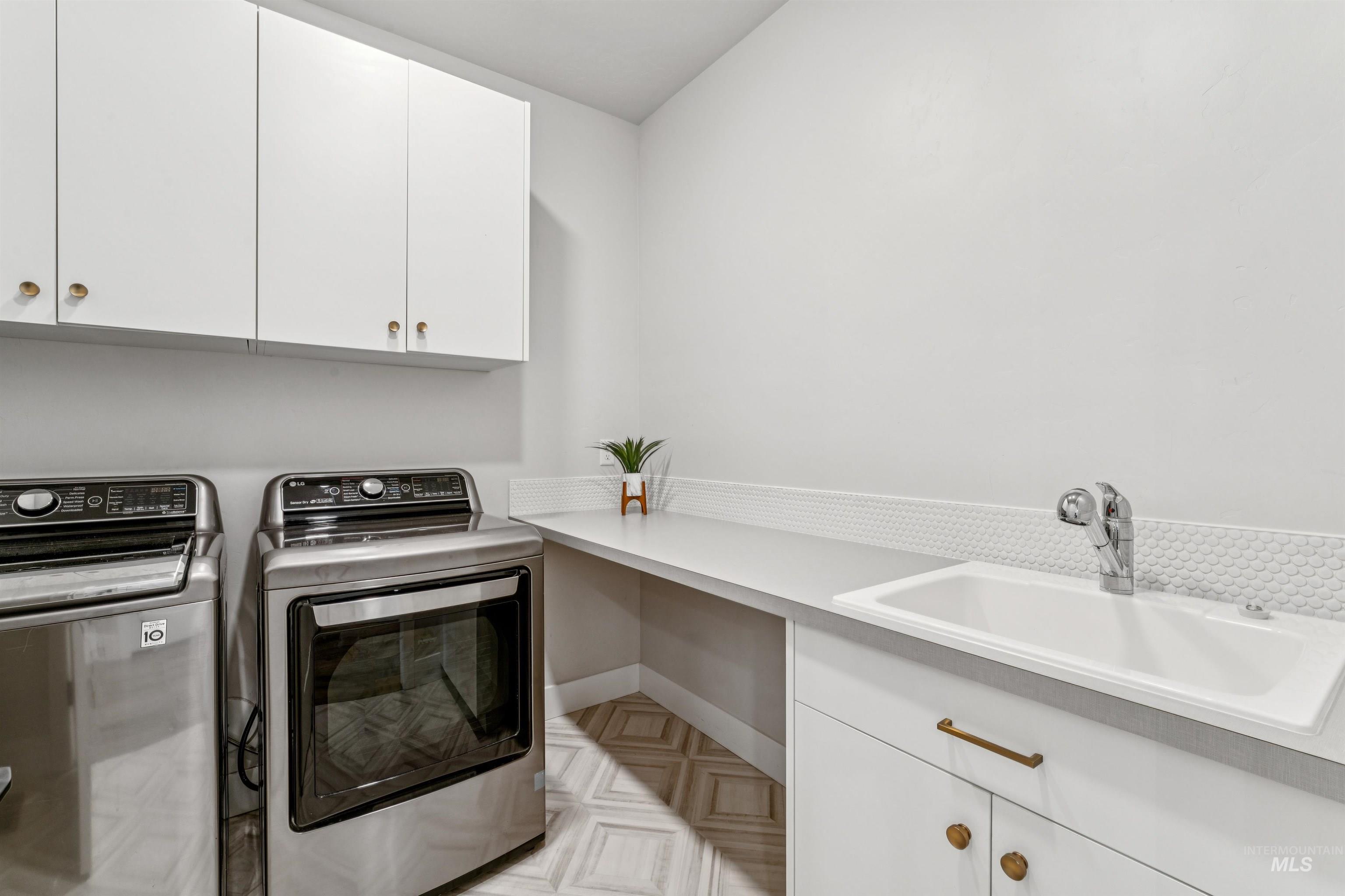 Laundry area featuring cabinet space and washing machine and dryer