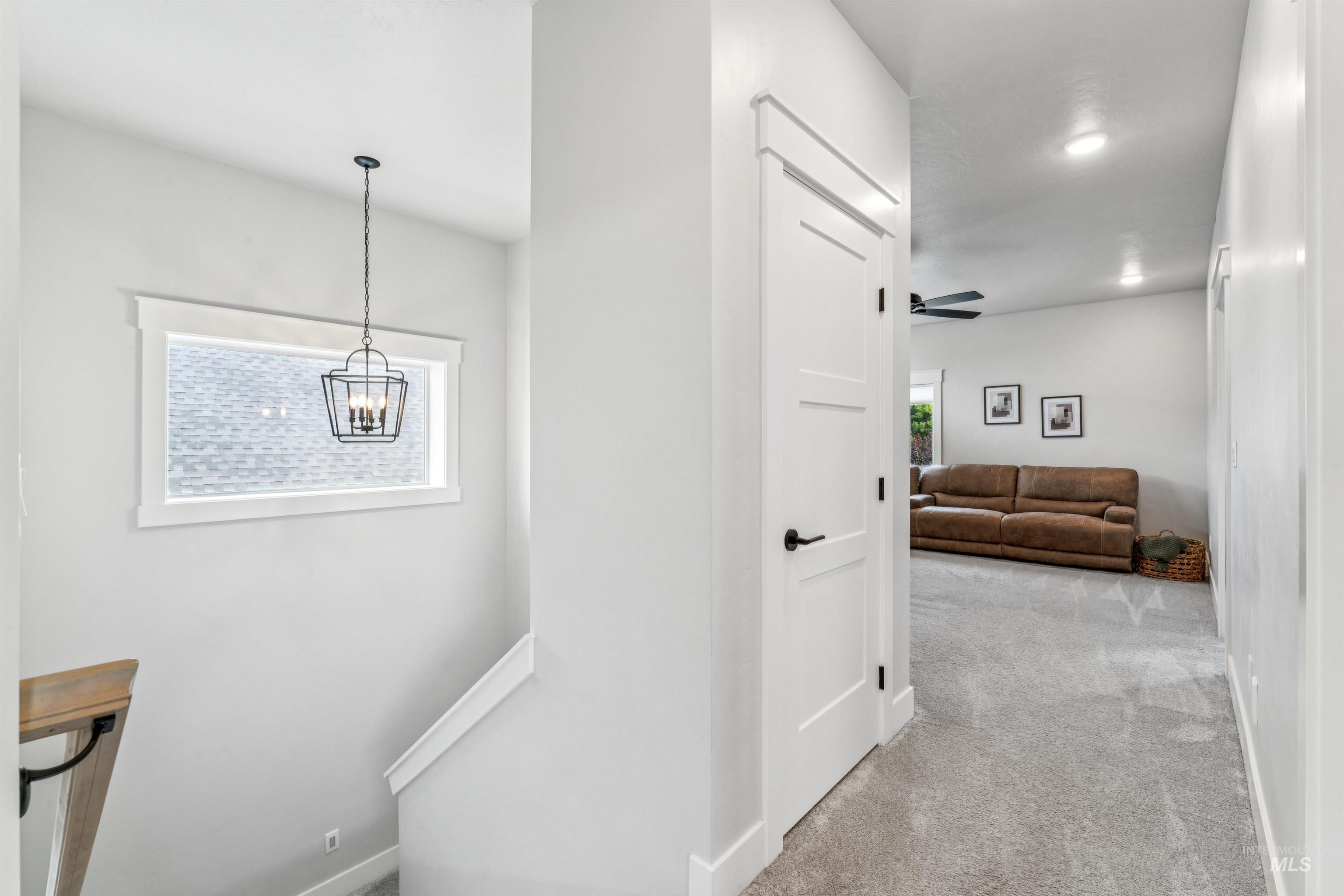 Corridor with light colored carpet