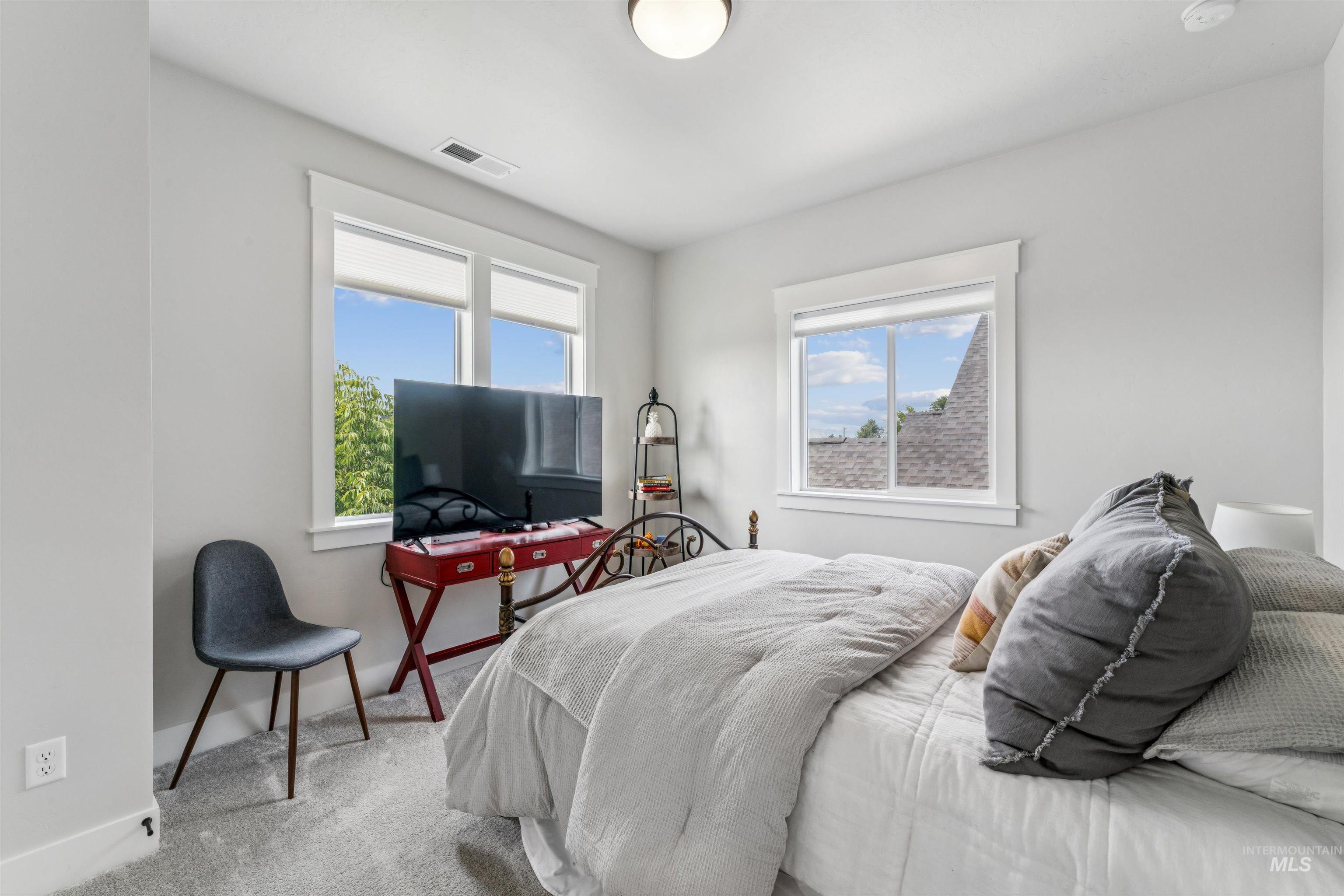 Carpeted bedroom featuring baseboards