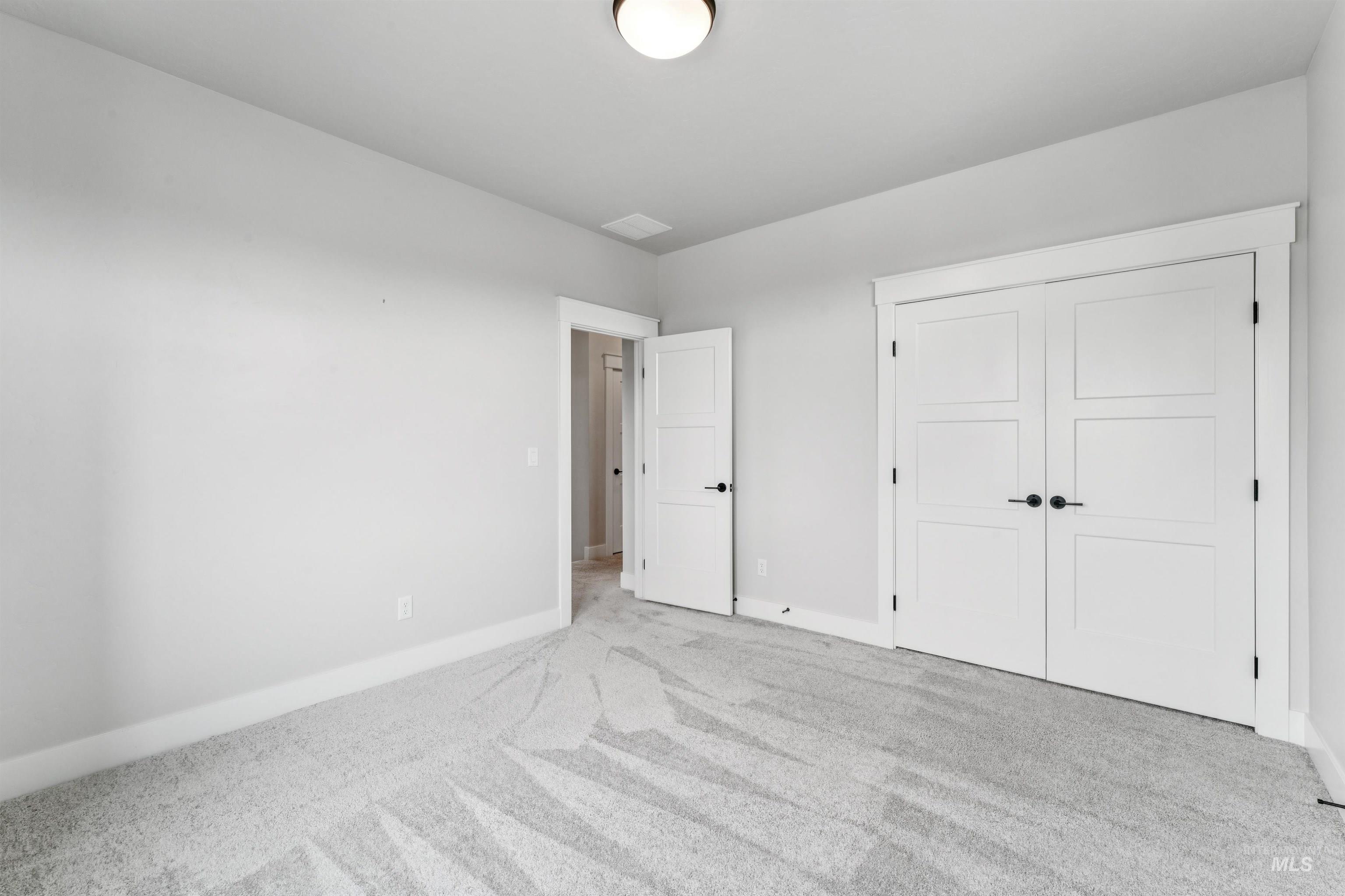 Unfurnished bedroom featuring carpet flooring and a closet