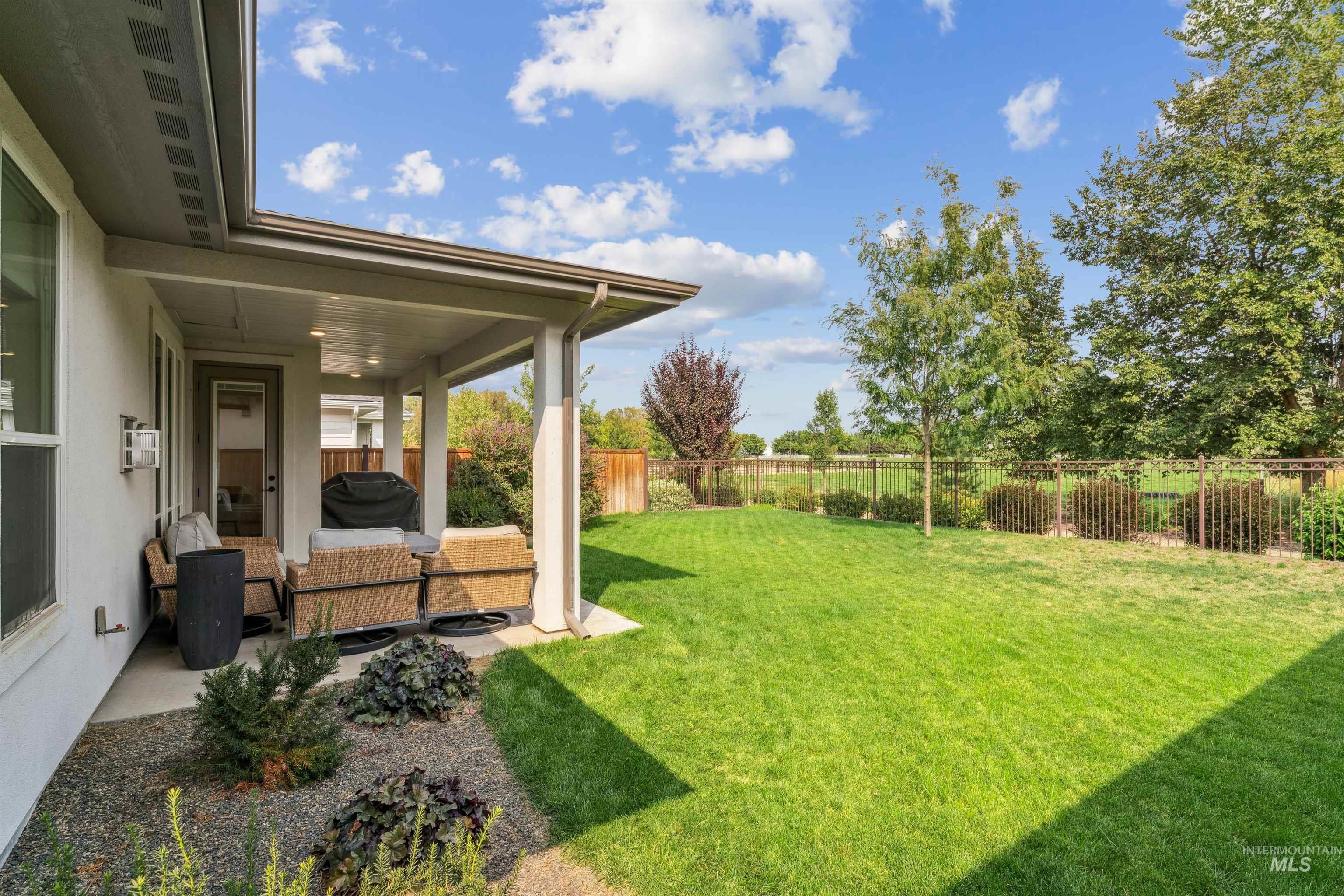 Fenced backyard featuring a patio