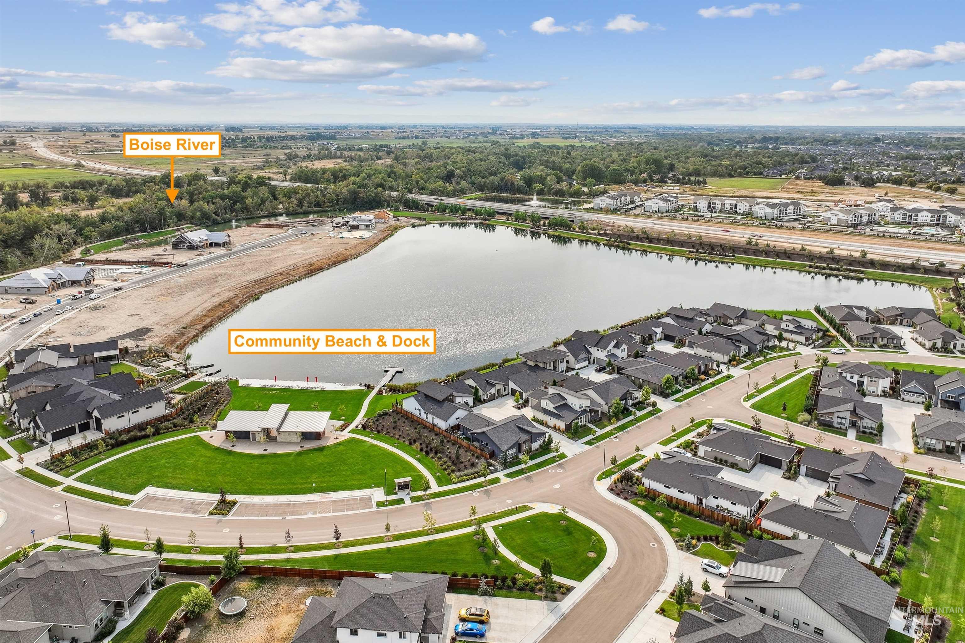 Aerial perspective of suburban area featuring a nearby body of water